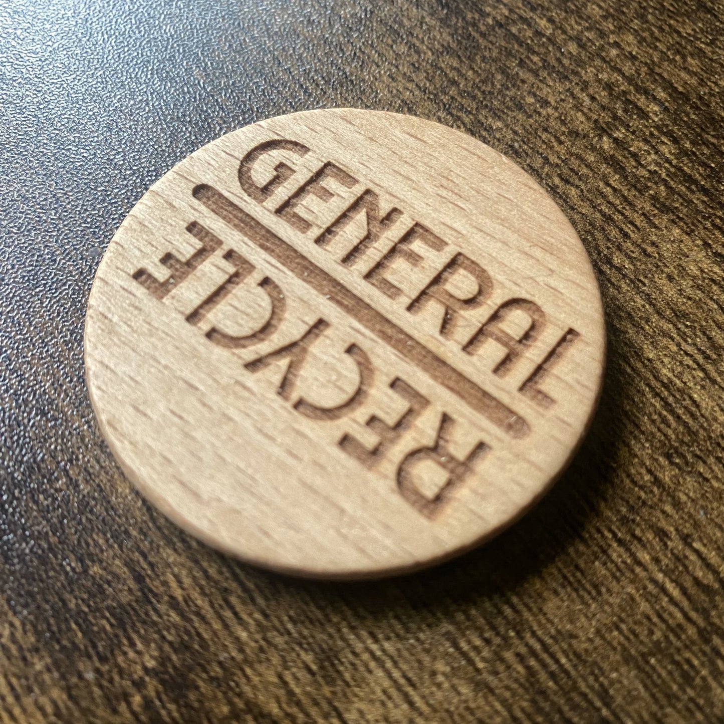 Angled close-up of wooden dial showing engraved bin labels for chore reminders - Words Variation.