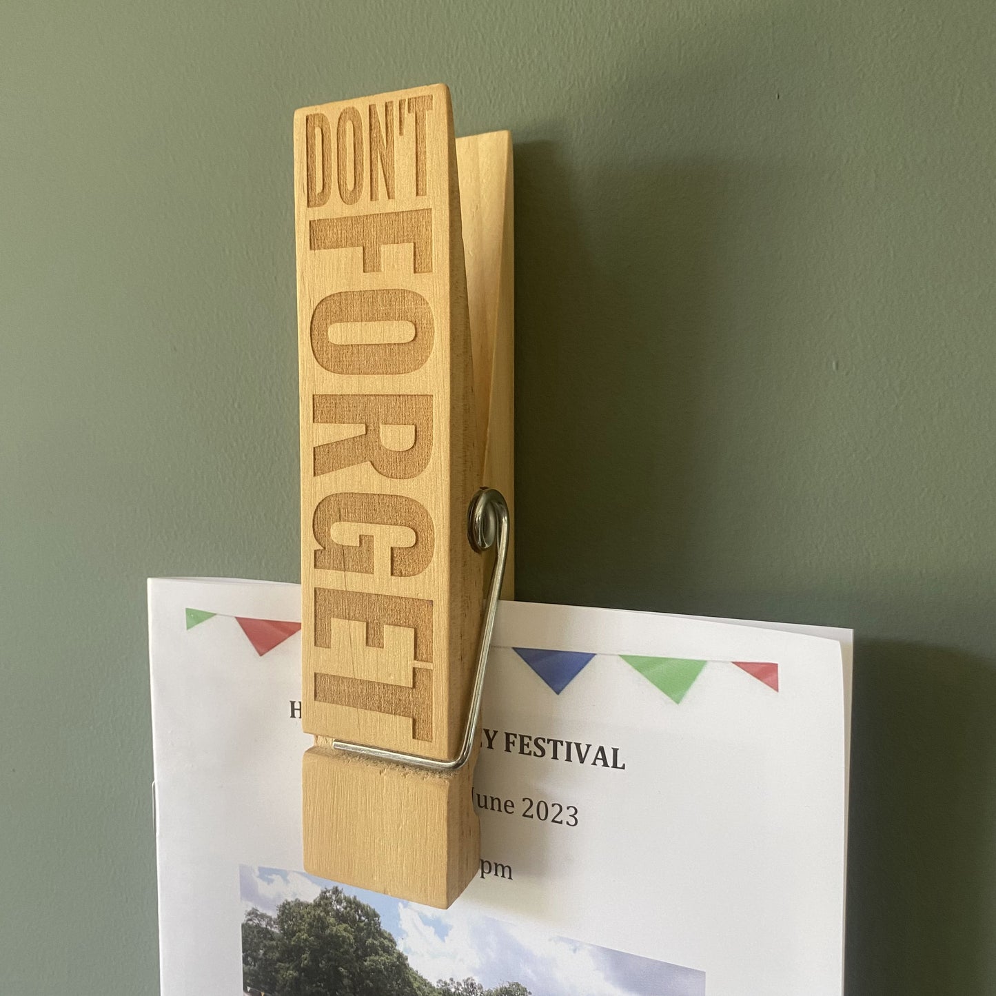 Jumbo Peg holding programme on a wall, reminding you of important moments.