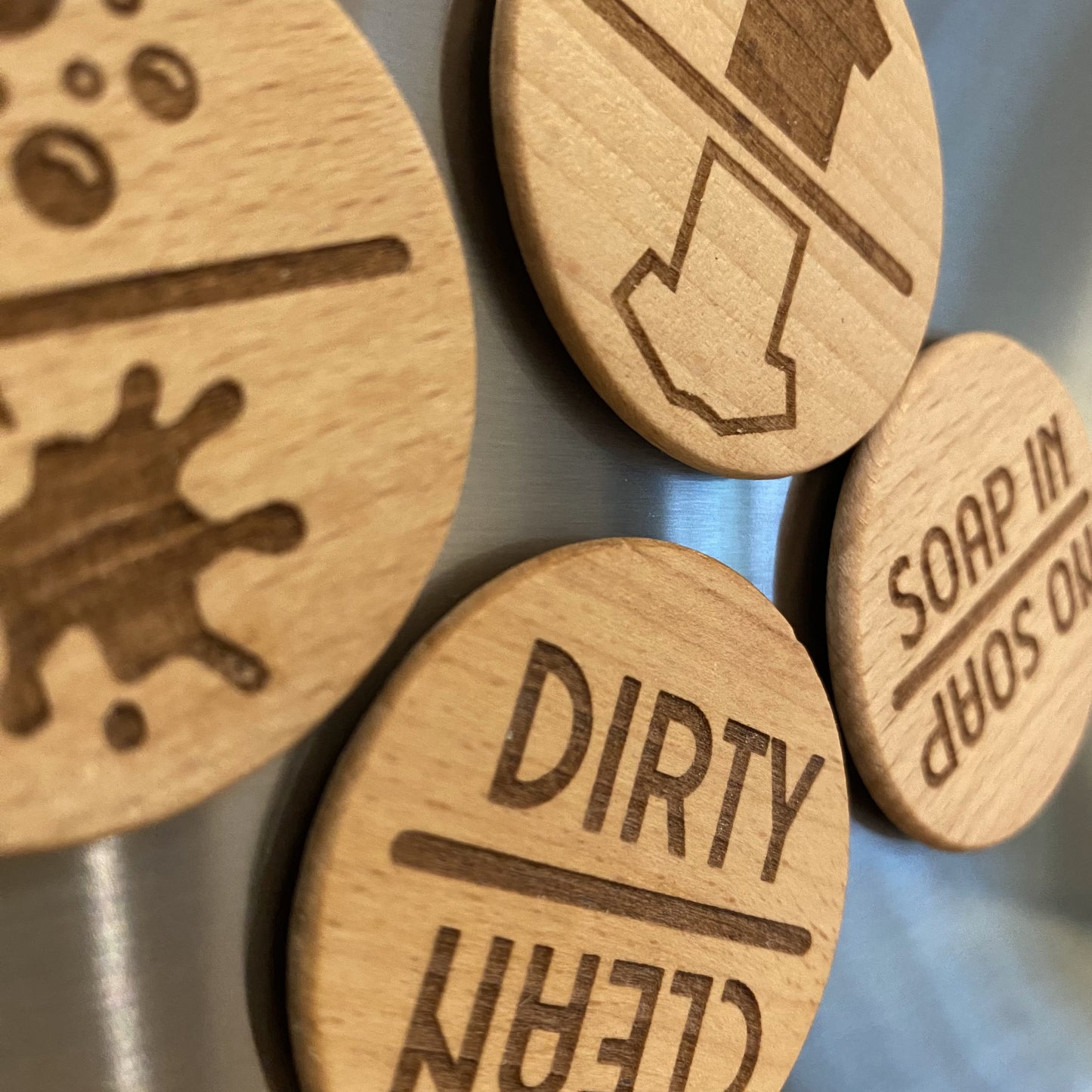 A selection of four different Spinning Chore Reminders, mounted on a fridge, showing various designs for home organisation.