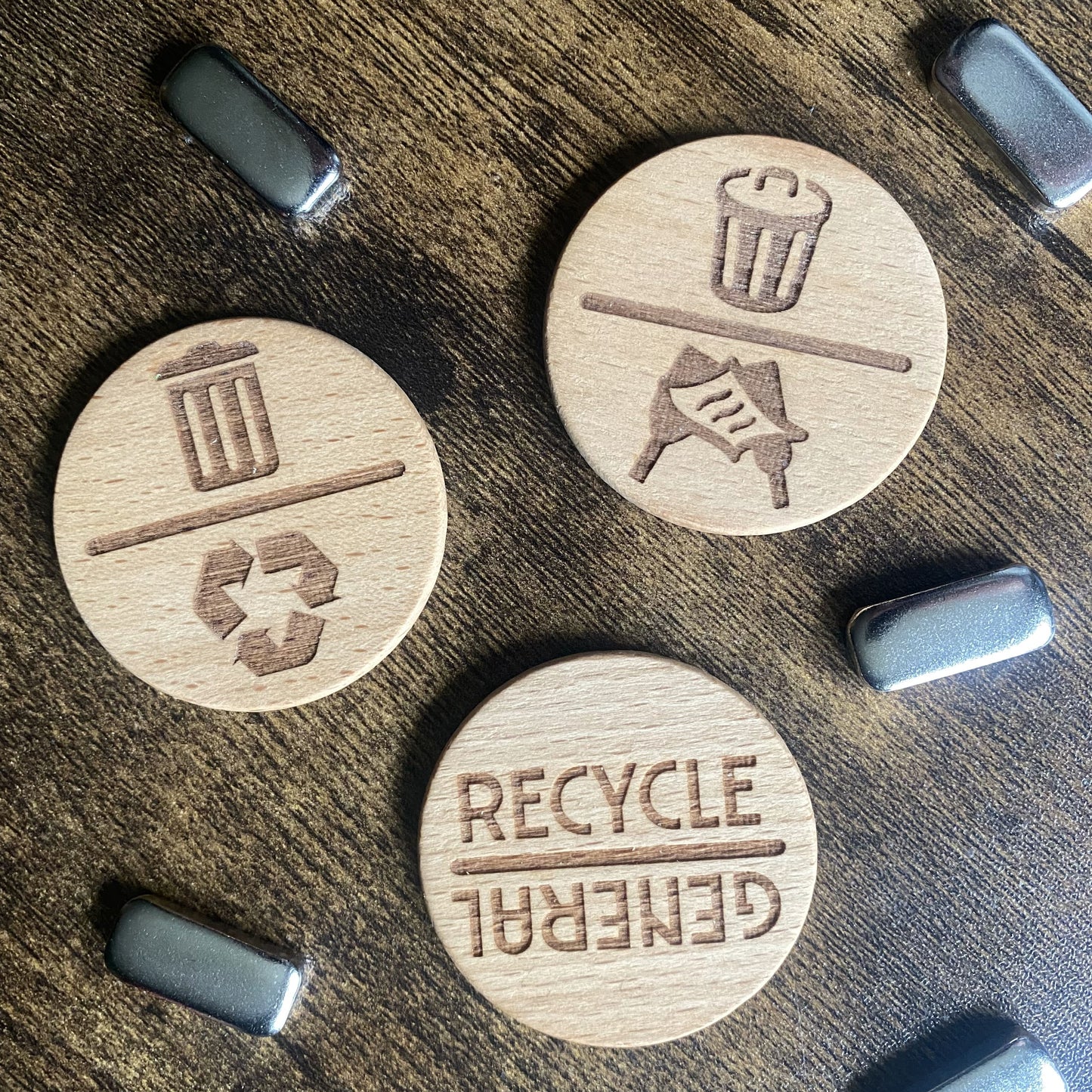 Wooden spinning reminder dials displayed with striker buttons on tabletop, highlighting materials and design details.