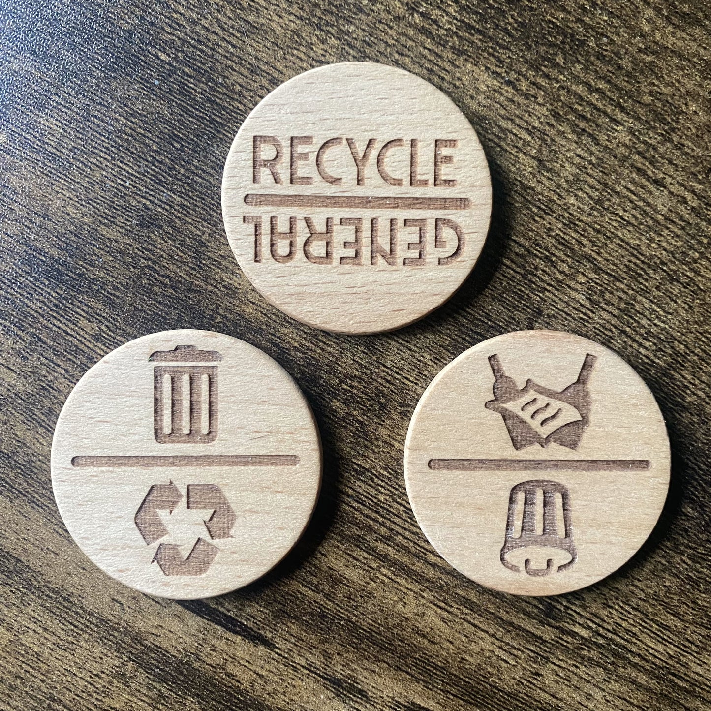 Top-down view of three spinning chore reminder dials showing different bin week and recycling options.