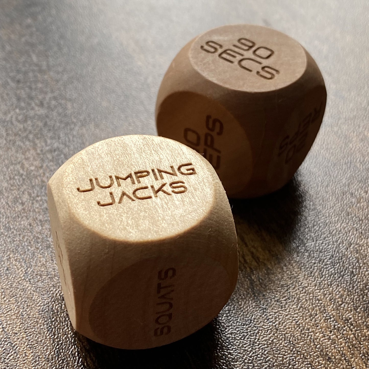 Angled close-up of Adult Exercise Decision Dice showing detailed engraved exercises and tactile wooden finish