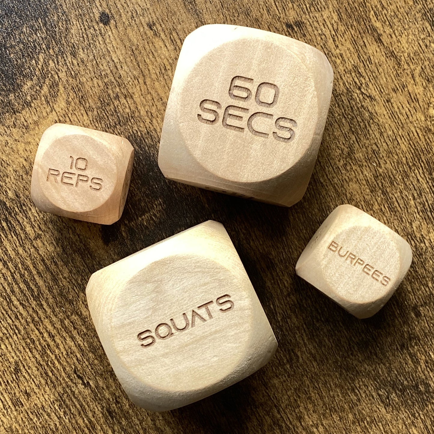 Top-down image showing two sizes of Adult Exercise Decision Dice side-by-side for workout flexibility