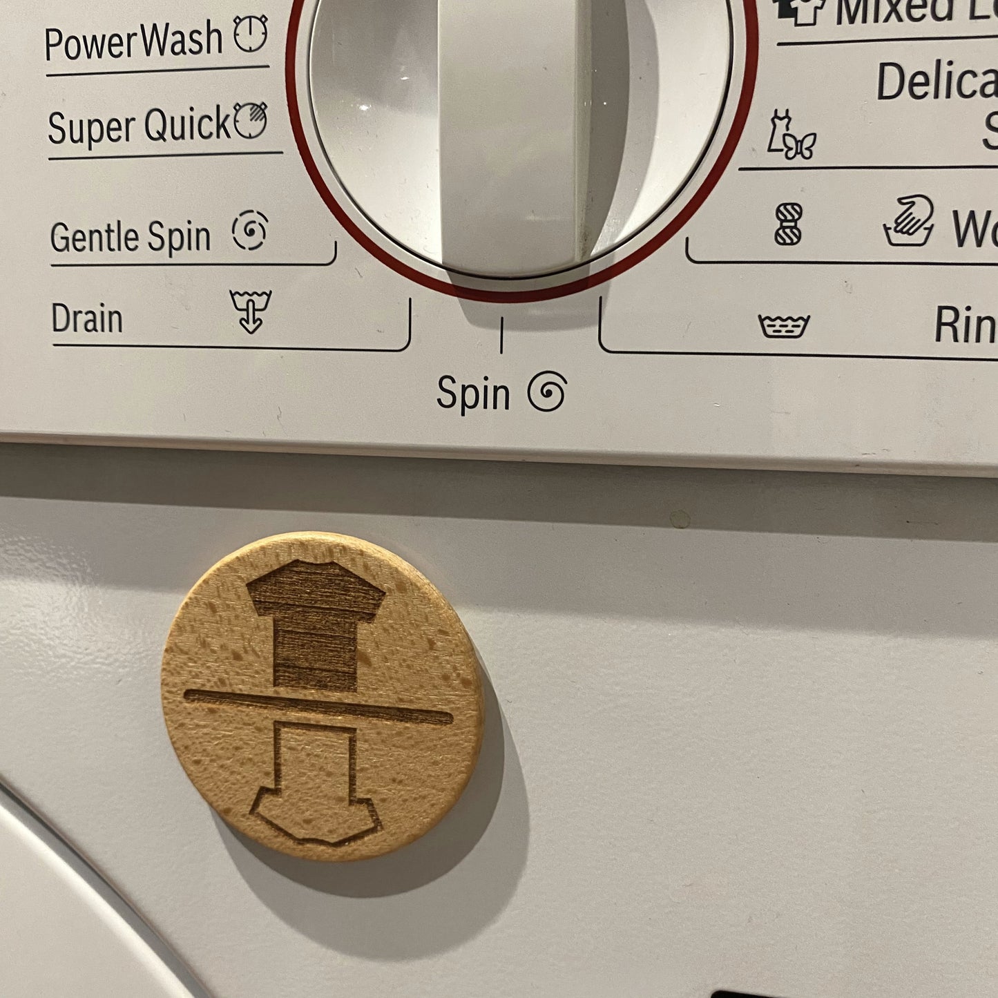 Laundry-themed chore reminder dial with t-shirt icons – designed for use on washing machines or dryers.