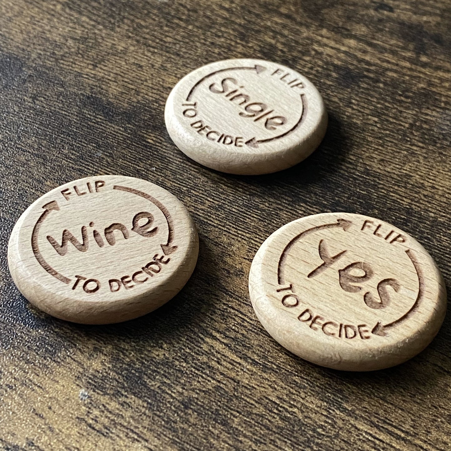 Close-up of the Arrow design on the Friday Night Drinking Trio Flip Coins, showing detailed wood engraving