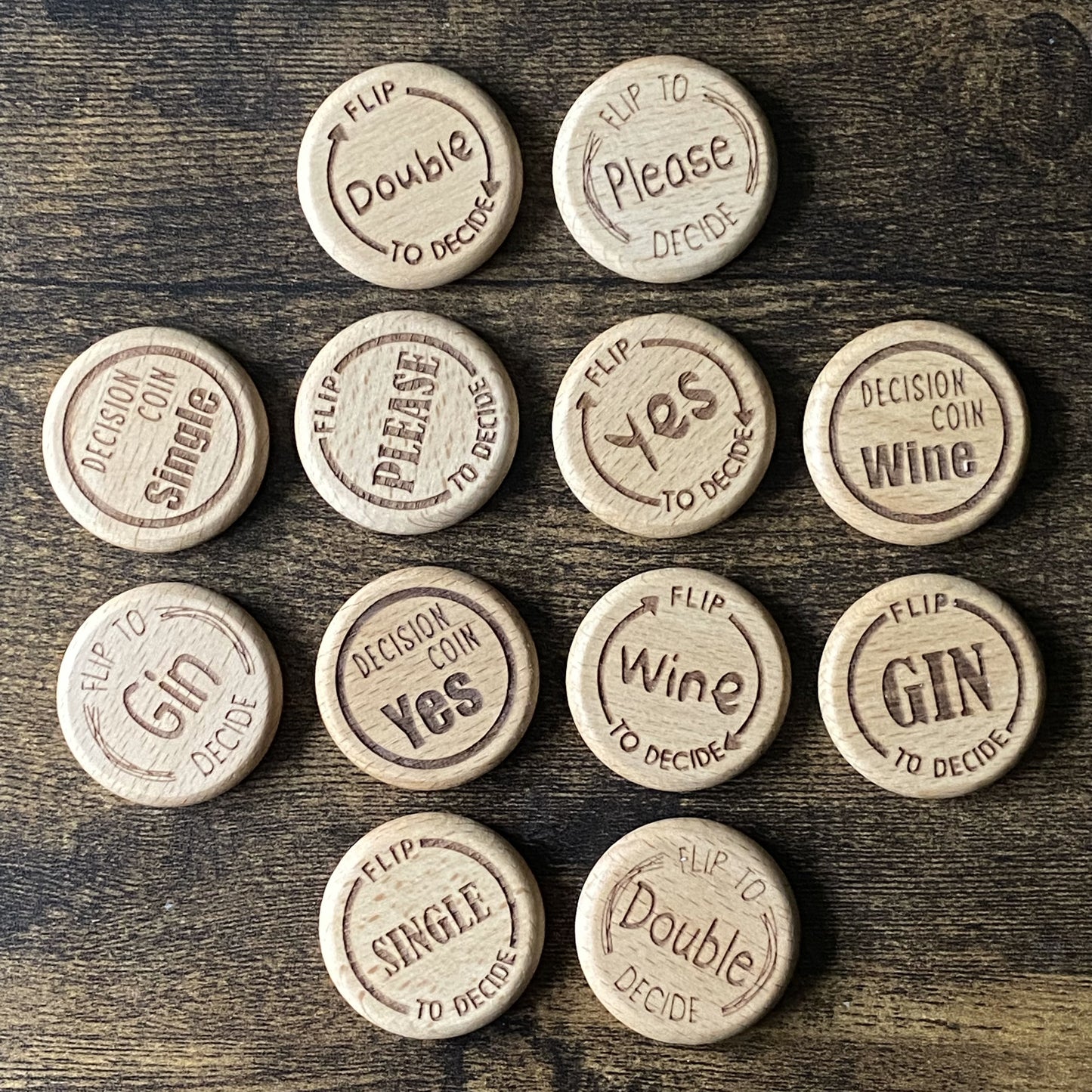 Top-down view of Friday Night Drinking Trio Flip Coins in a mix of all four designs, arranged to show engraving detail and variety