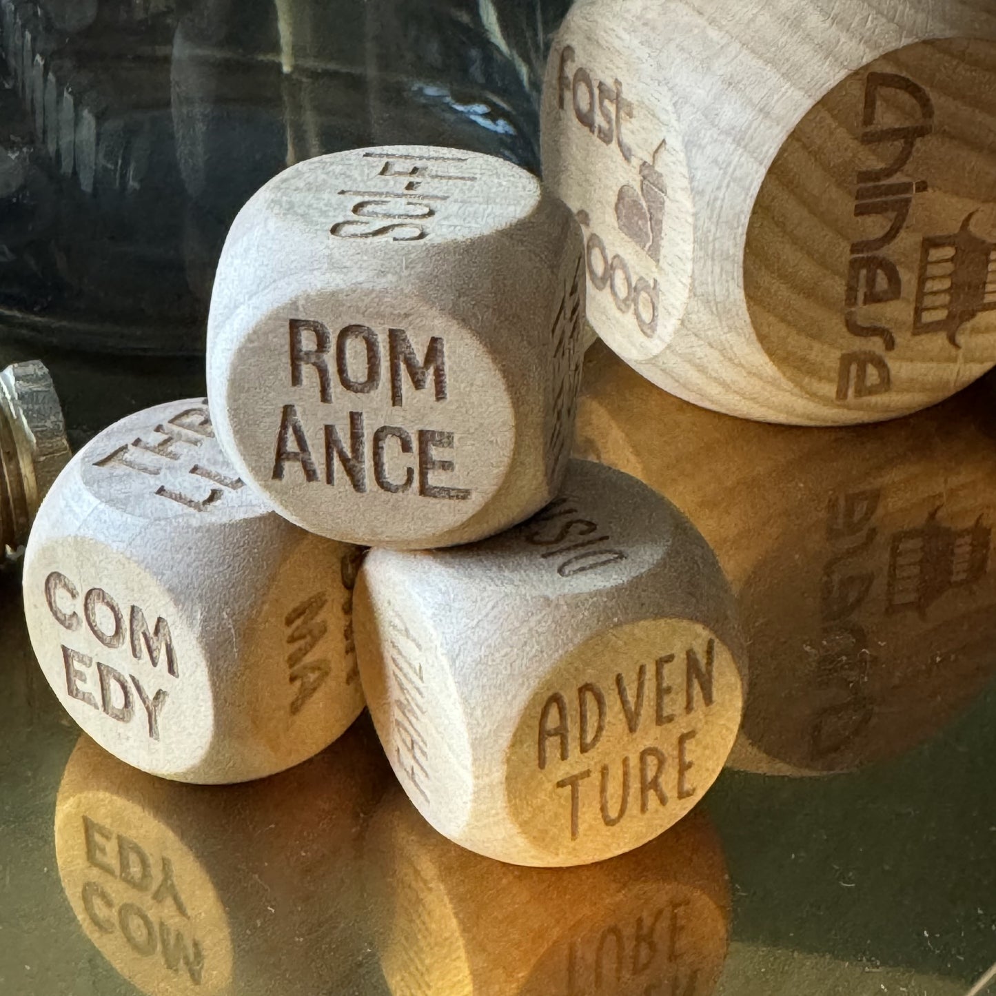 Engraved Movie Dice Trio displayed on a brass tray, with takeout dice in the background, perfect for Friday nights in
