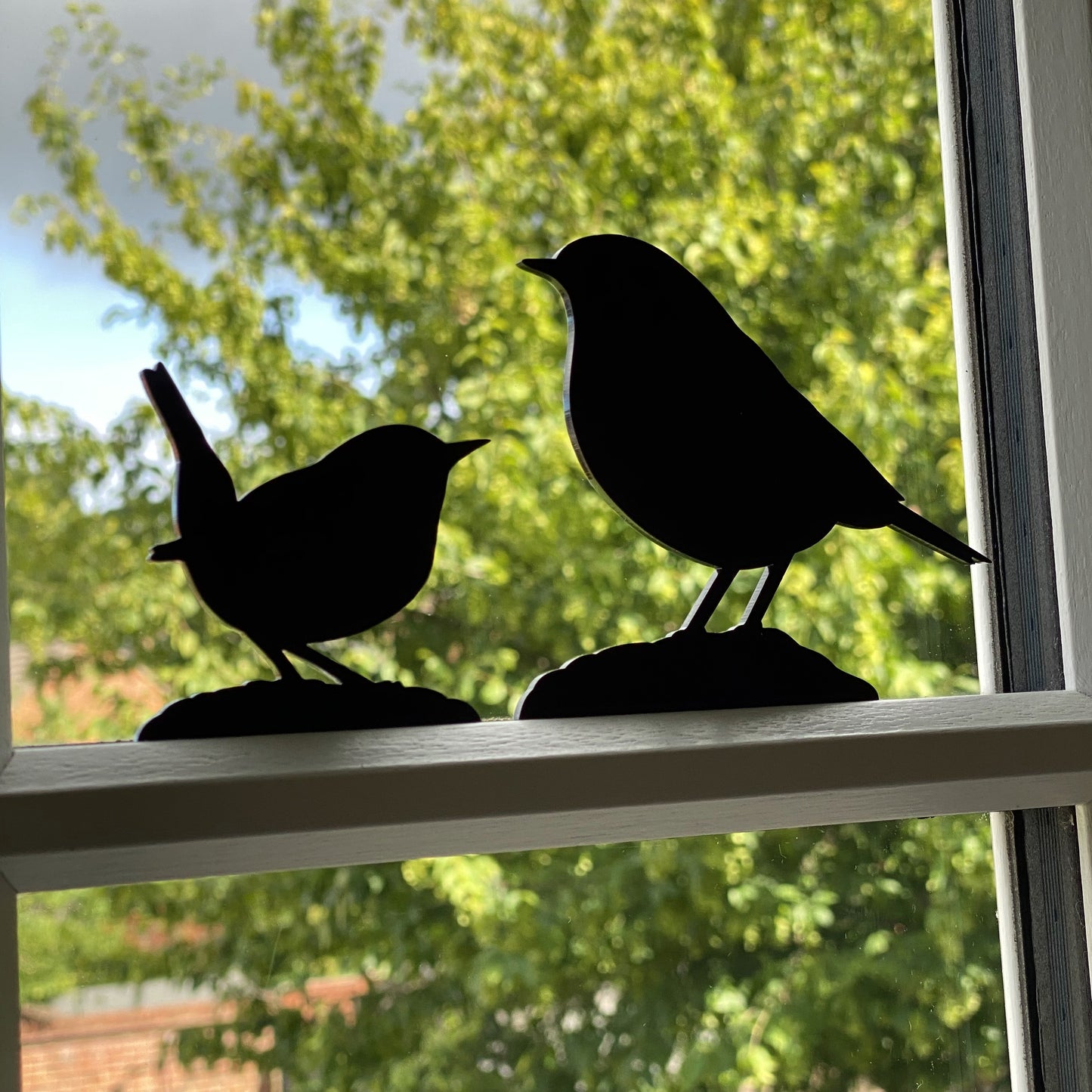 Minimalist bird sculptures in matt black, designed for indoor and outdoor use including robin, wren, and more