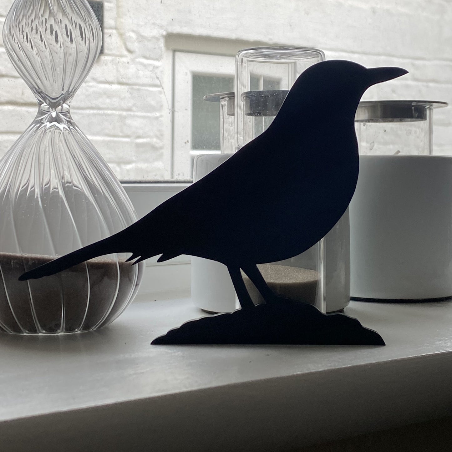 Minimalist blackbird garden sculpture with elegant profile