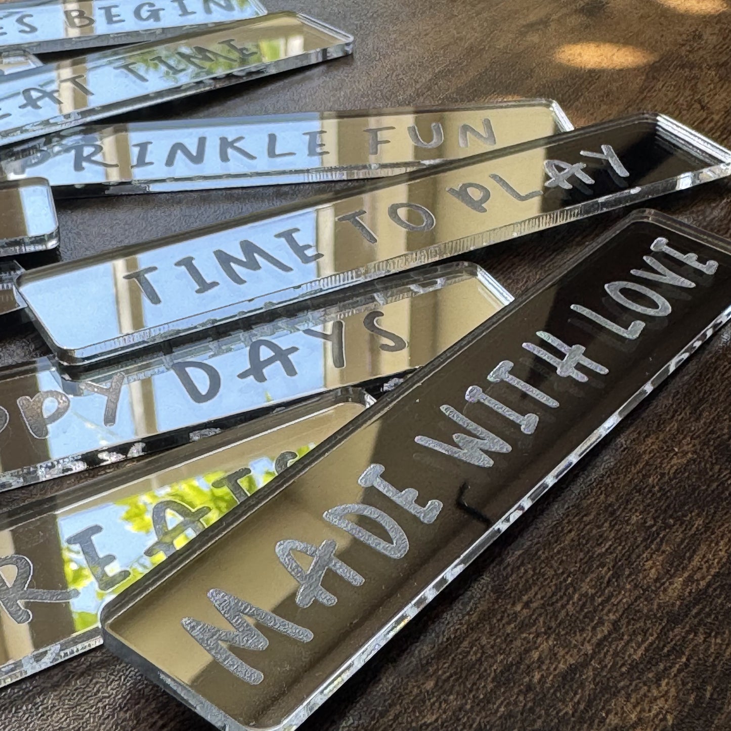 Sweet Sprinkles engraved messages displayed in a scattered arrangement reflecting in sunshine