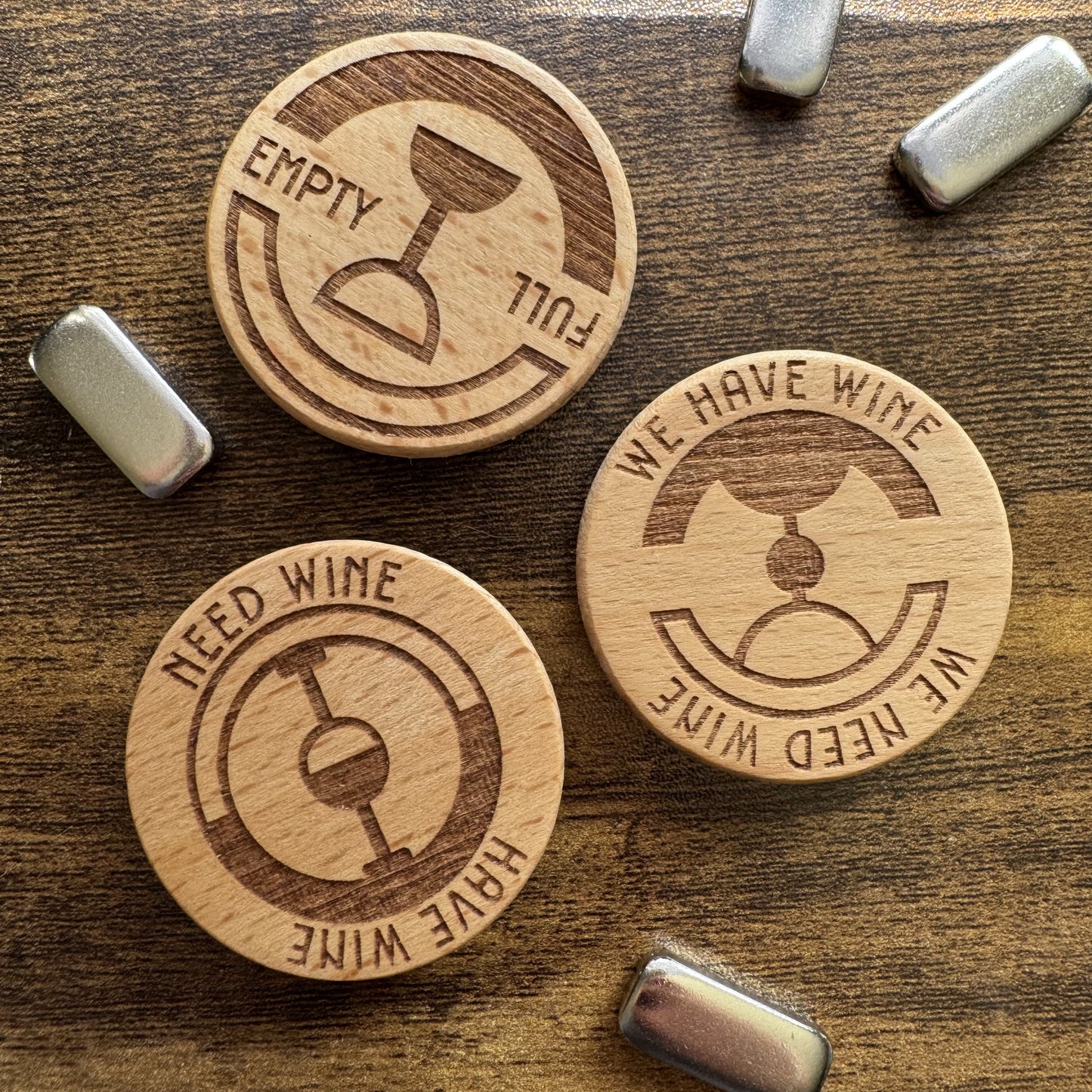 Top-down view of three 'The Wine Dial' designs displayed together with magnetic keepers