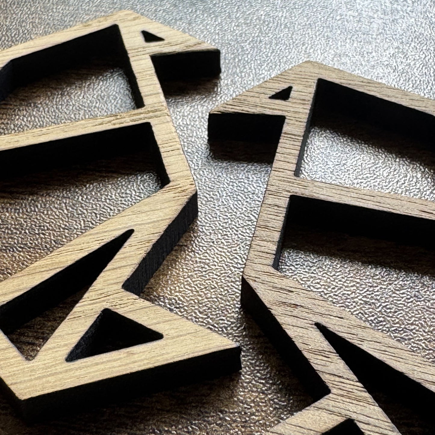 Close-up of wooden origami-style bird pair in oak and walnut – clean lines and crafted detail