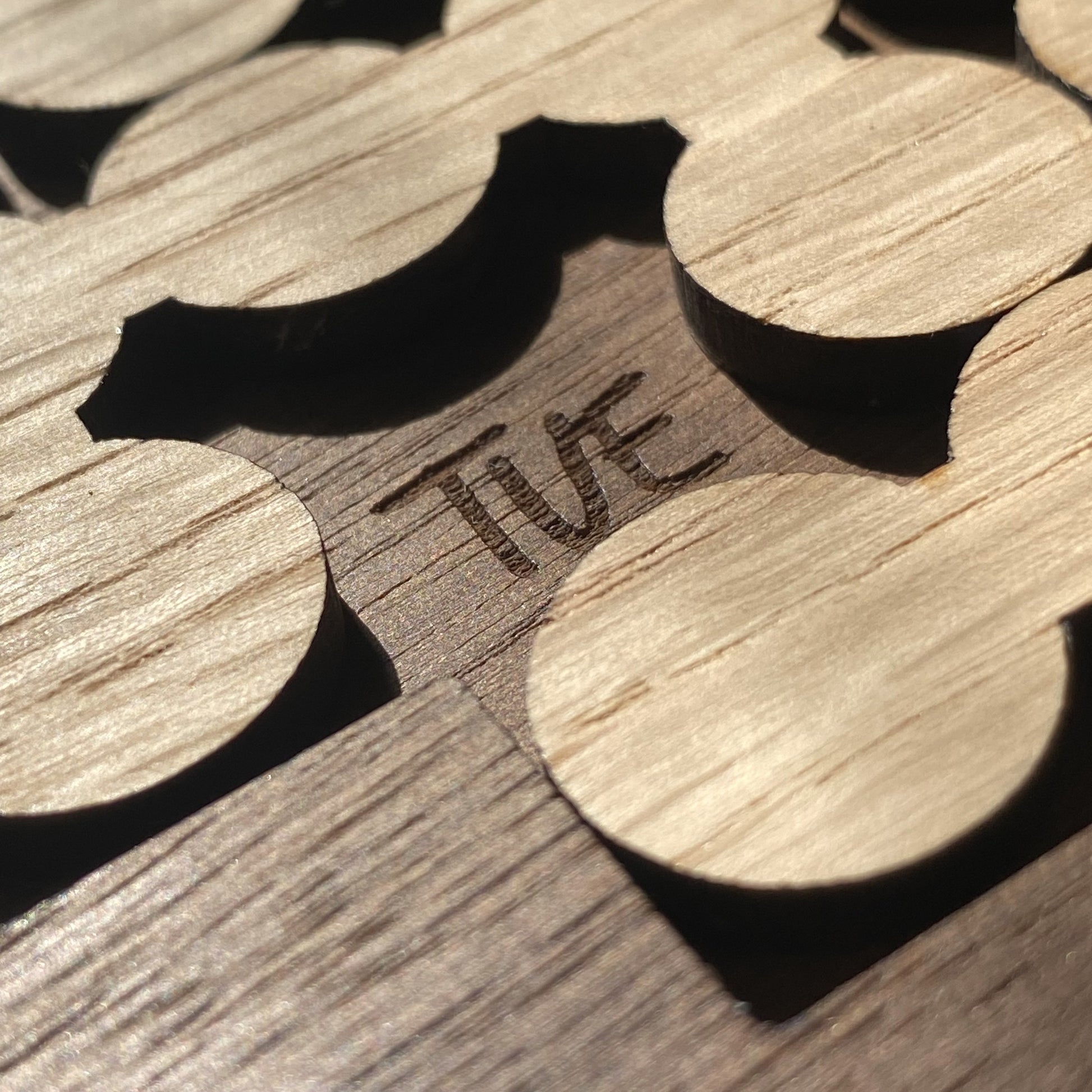 Close-up of oak bubble with professional engraving, showcasing detailed craftsmanship on the Daily Perpetual Calendar Puzzle.