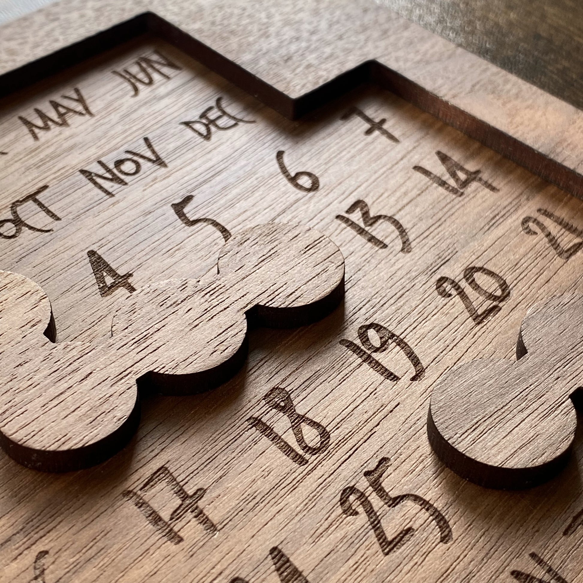 Close-up of Daily Perpetual Calendar Puzzle pieces, highlighting stunning engraving details and intricate craftsmanship.