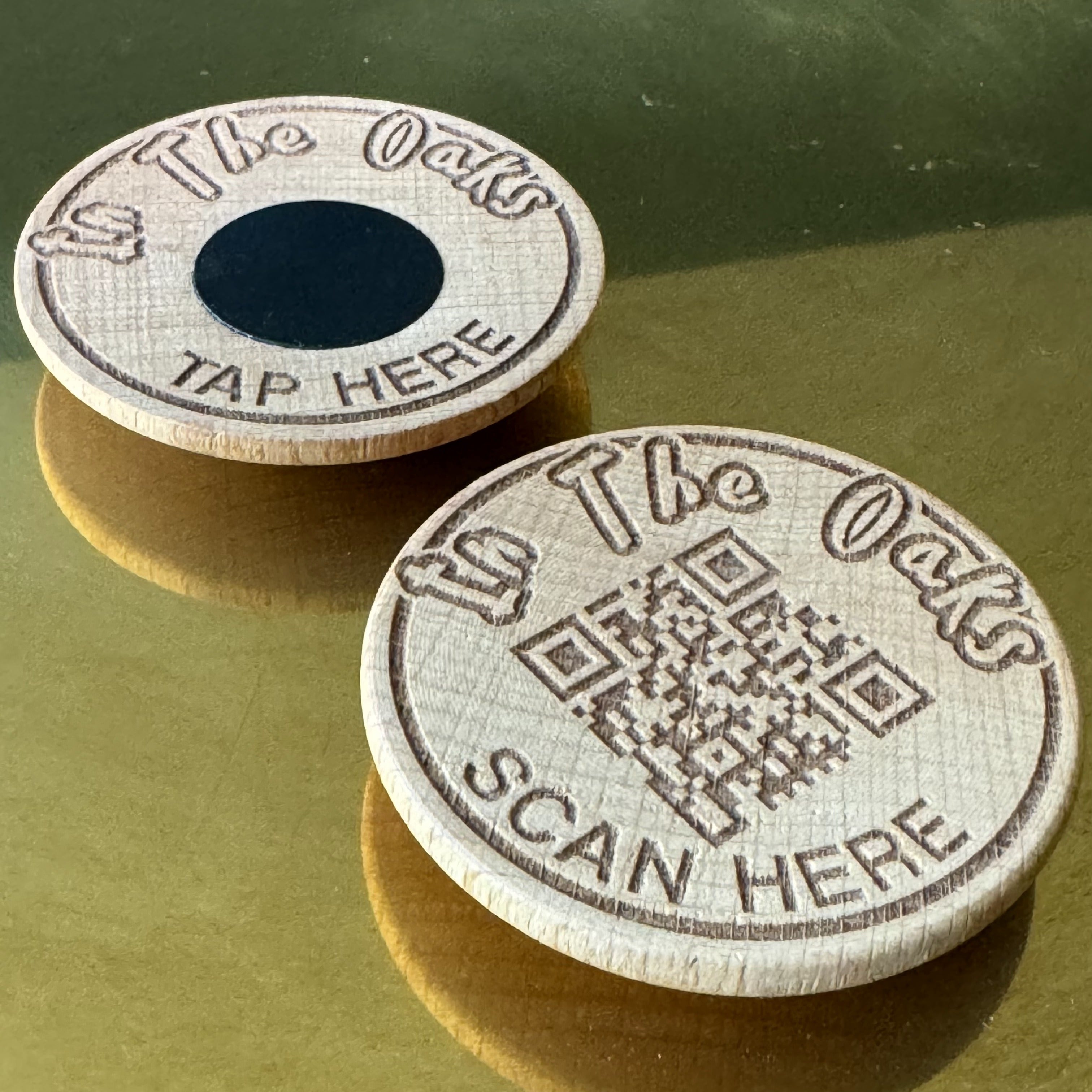 Company display featuring engraved QR code and NFC tag paired on a wooden half-circle display discs