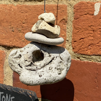 Weather forecasting plaque with multiple hag stones collected and displayed