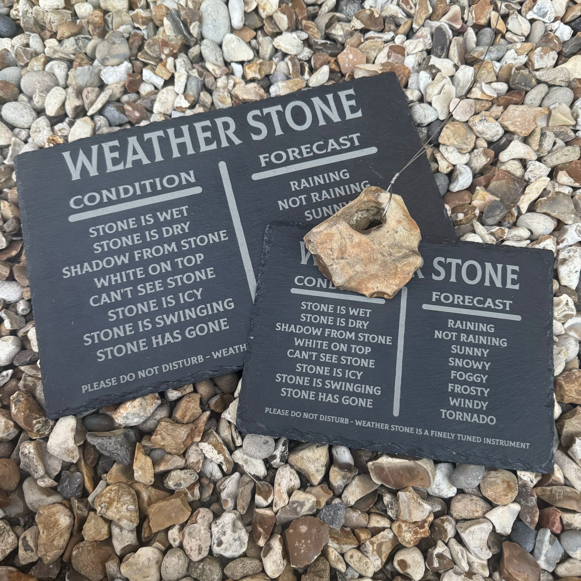Two sizes of weather stone forecasting sets shown on natural stone background