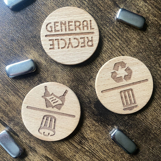 Spinning Chore Reminder dials laid out on a table with magnetic striker buttons, showing design and components.