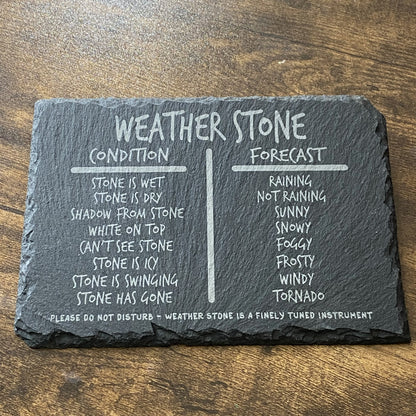 Slate weather sign with playful scrawl lettering and hanging forecasting stone