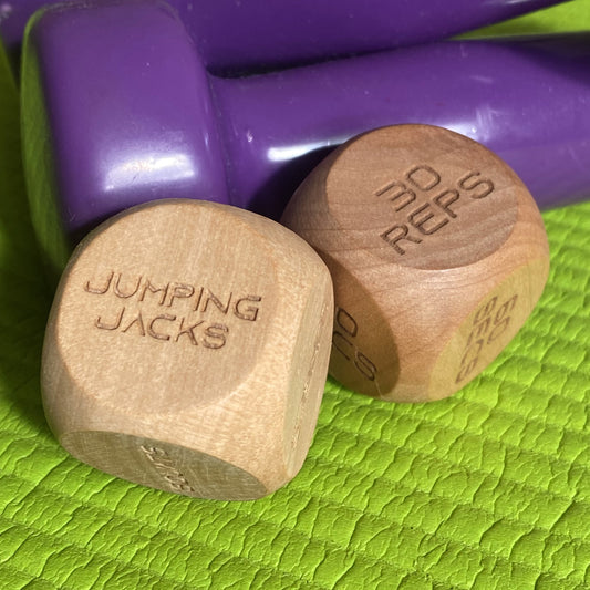 Adult Exercise Decision Dice displayed with home exercise equipment, highlighting workout variety