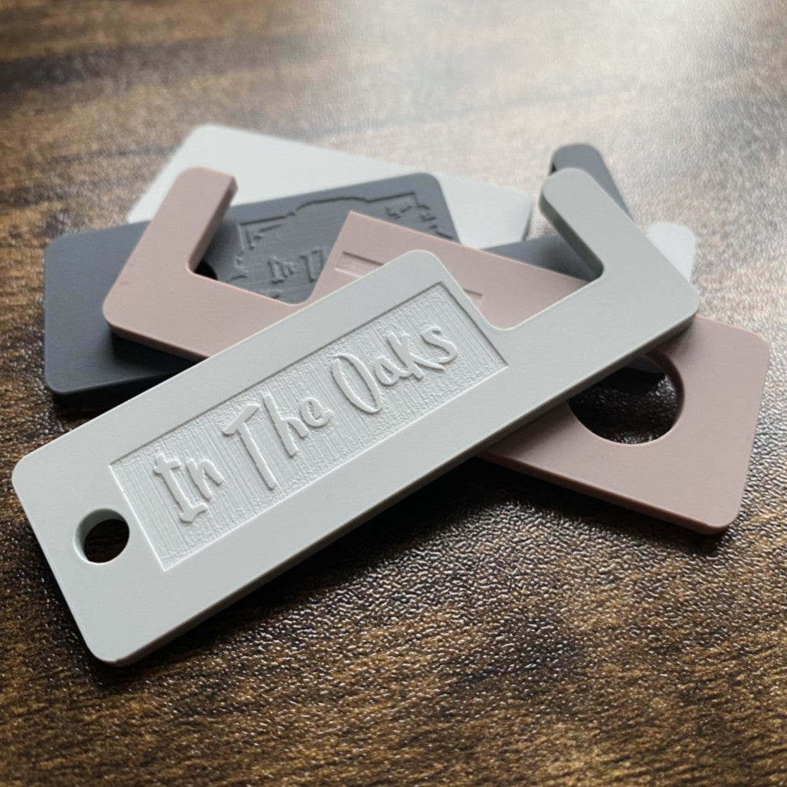 Compact branded keyring that doubles as a mobile phone foot holder, ideal for promotional gifting and everyday use