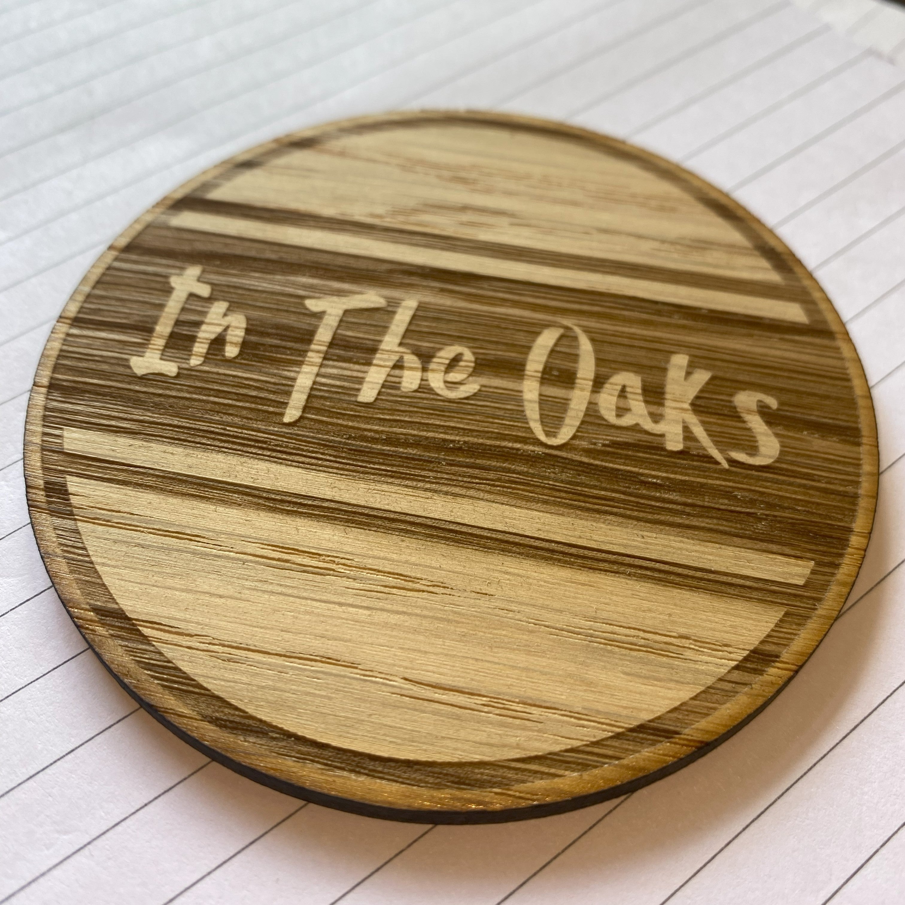Branded oak wooden coaster featuring company logo engraving
