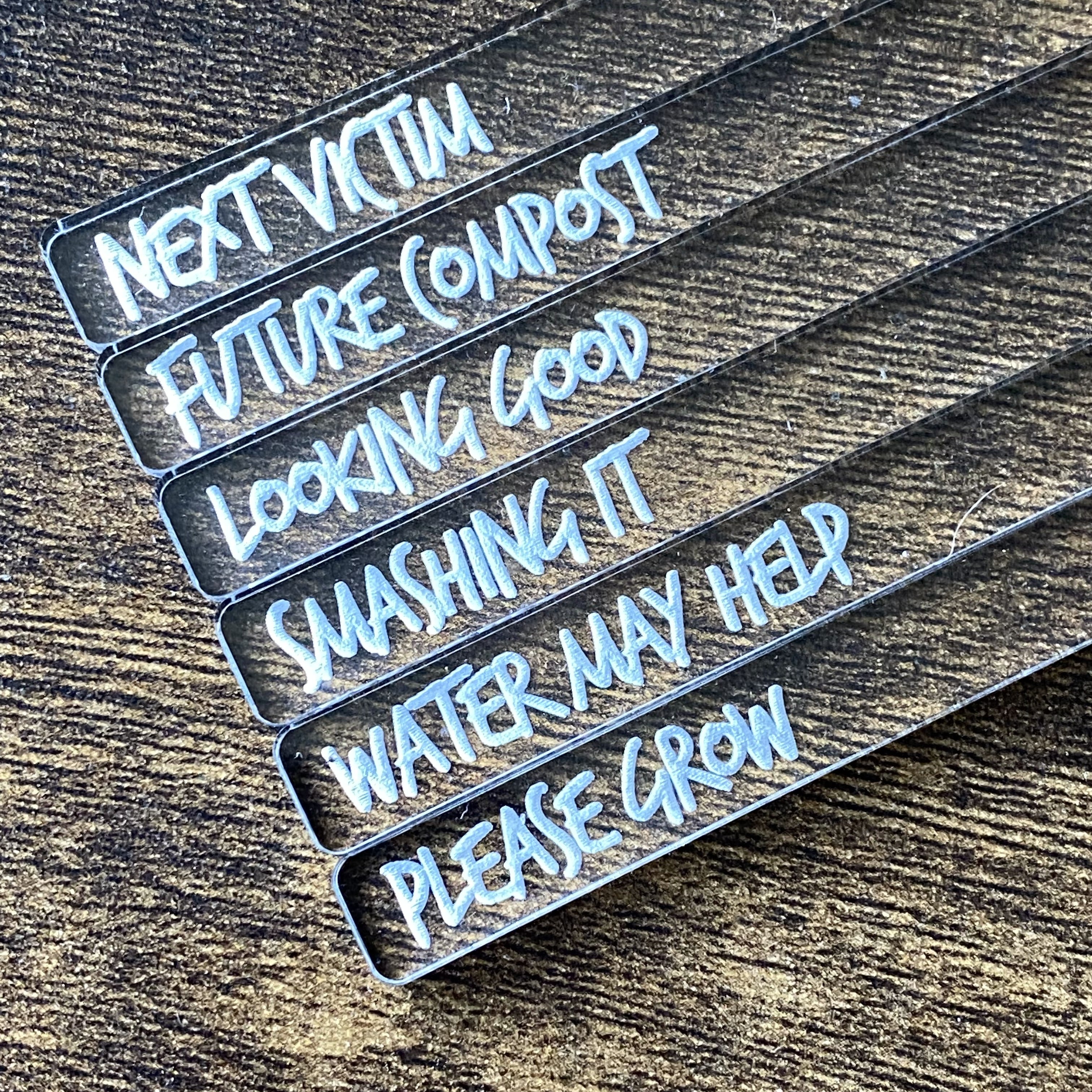 Set of clear acrylic plant markers engraved in an amusing graffiti-style font