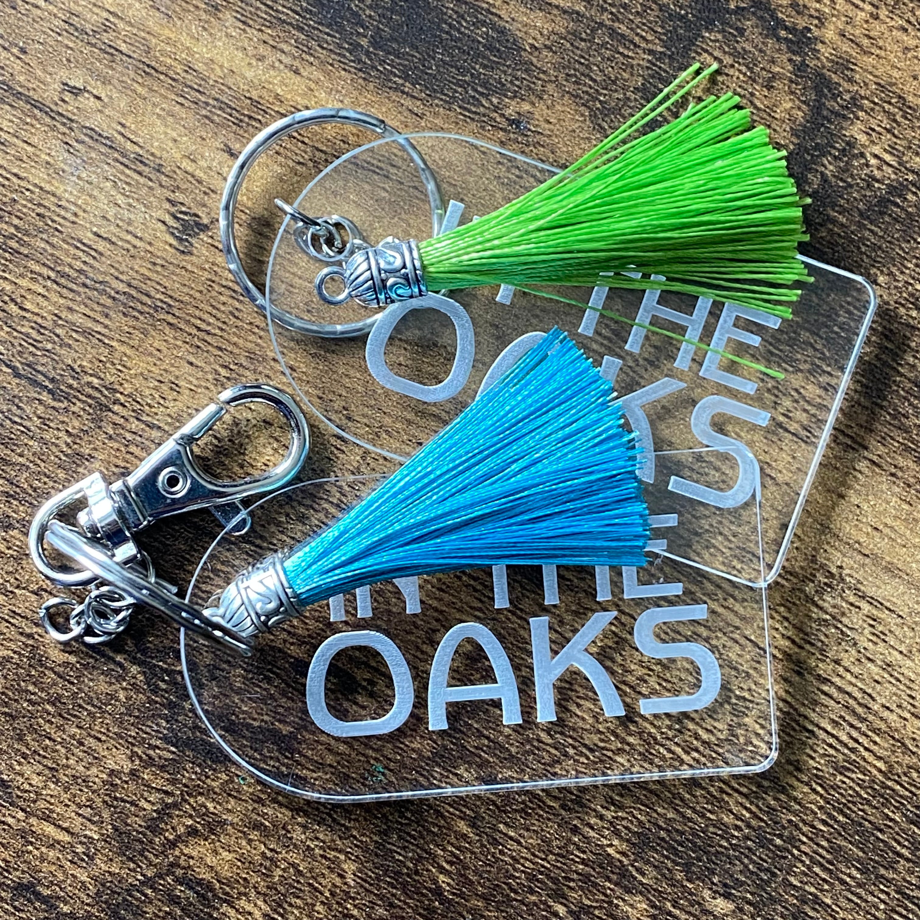 Personalised clear acrylic keyrings in a luggage label style, featuring detailed engraving and modern design
