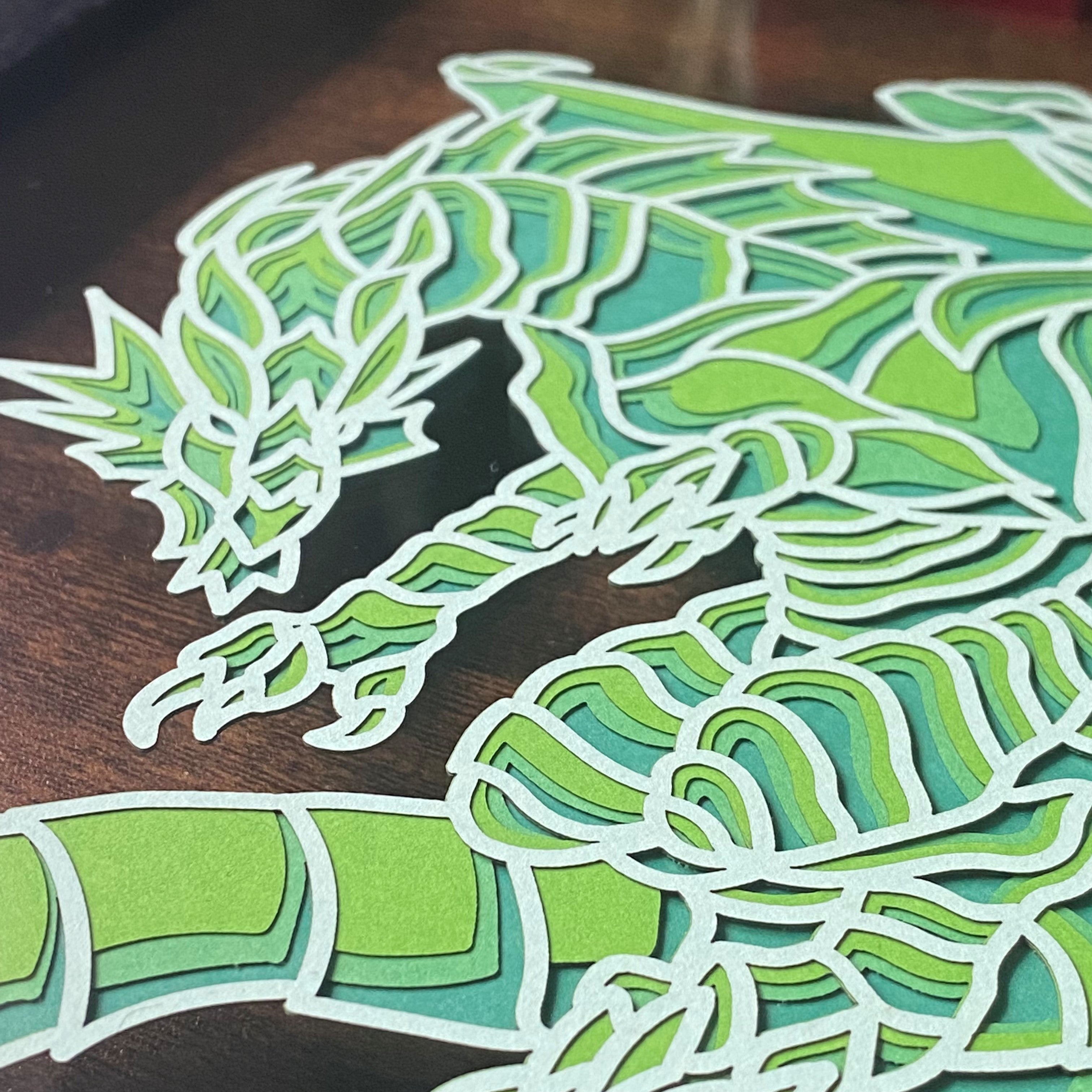 Close-up of intricate layered paper dragon art piece showcasing detailed craftsmanship