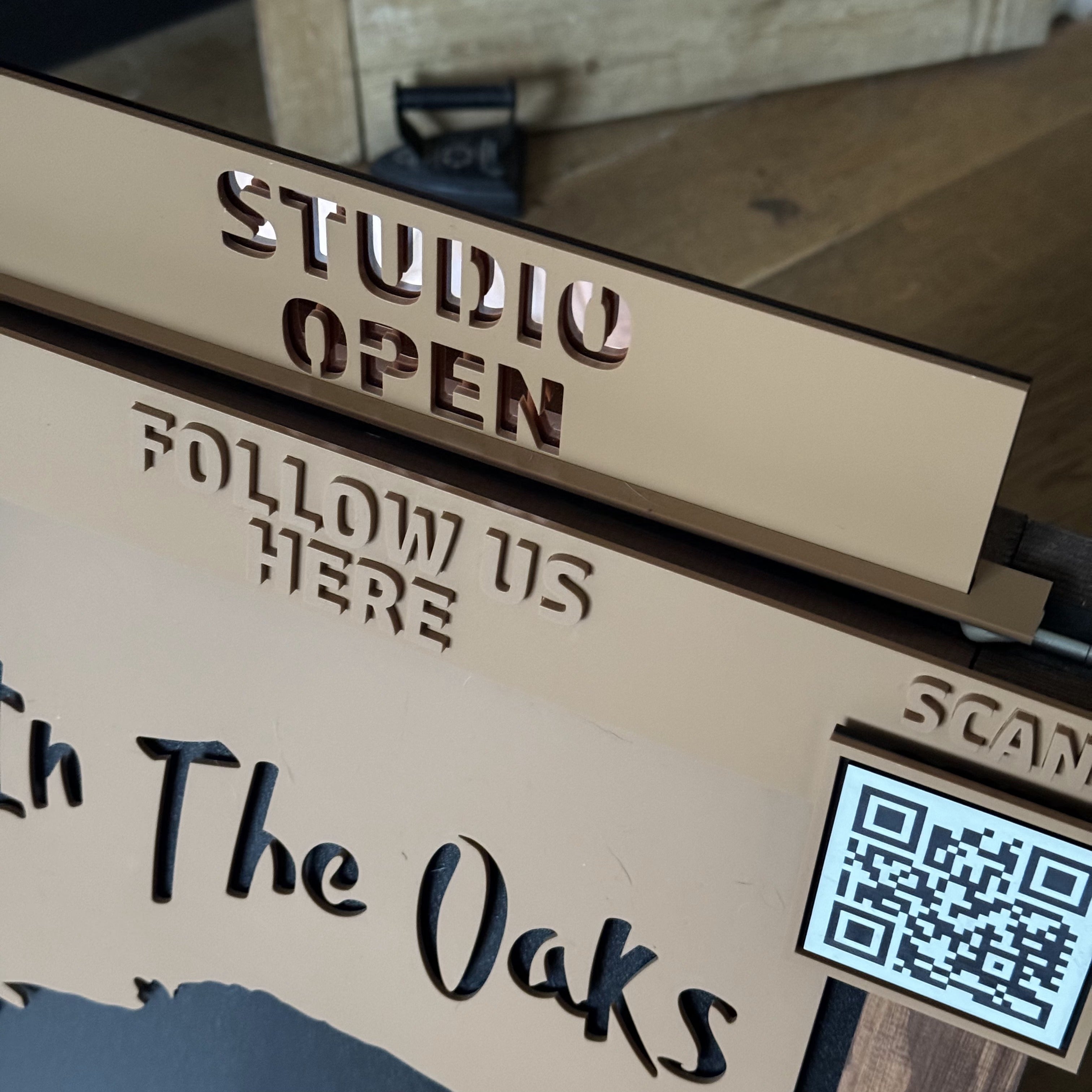 Close-up detail of ‘Open Studio’ sign showing bespoke design, materials and lettering