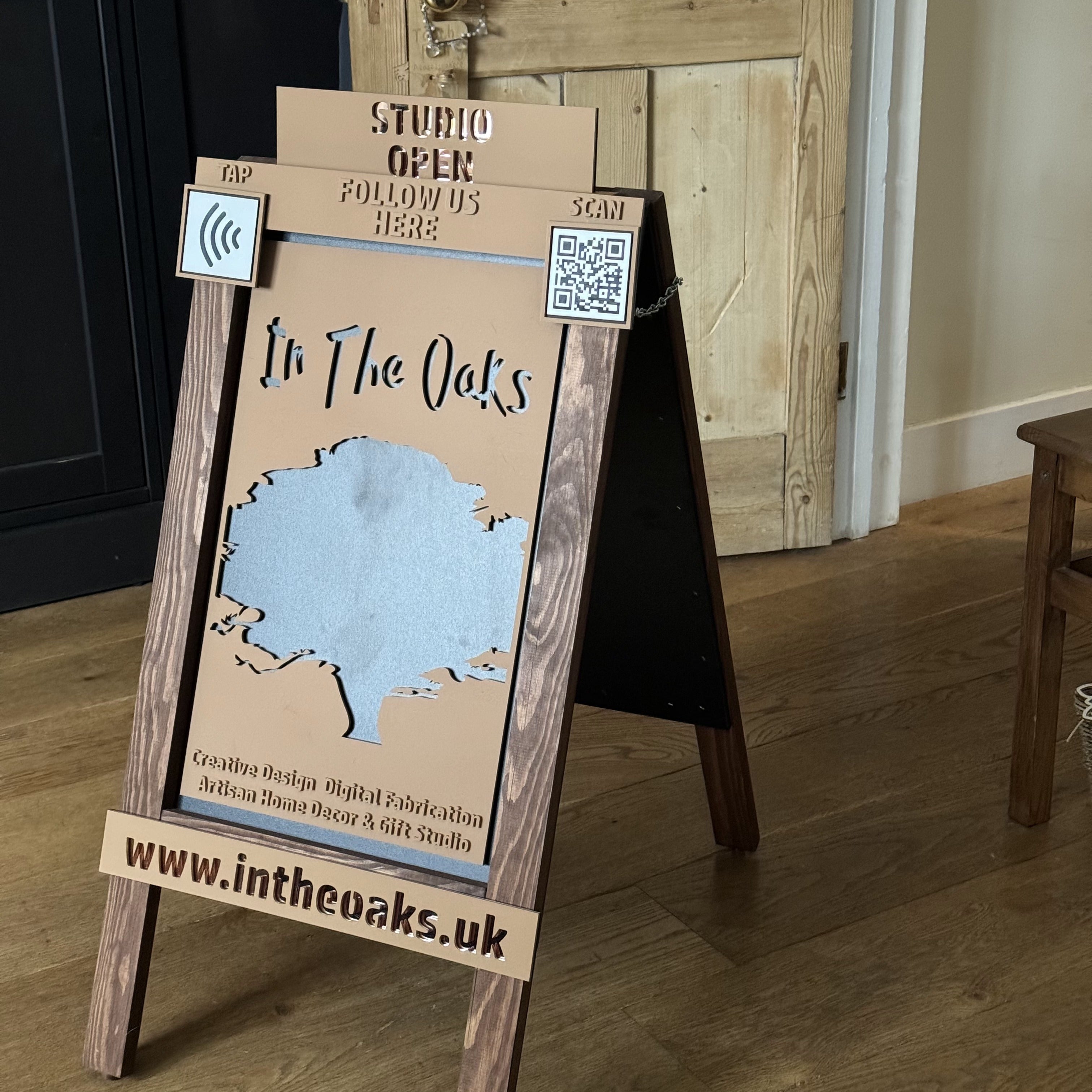 Custom designed and made pavement sign featuring relief lettering, mirror accents, NFC and QR code plaques, and website details


