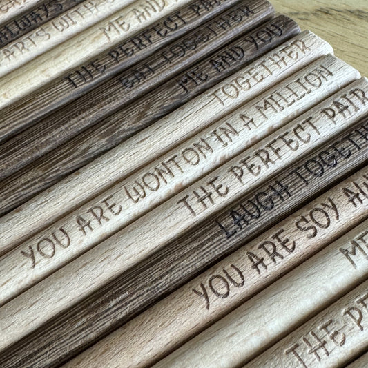 Close-up of engraved chopsticks lined up to show detail and finish.