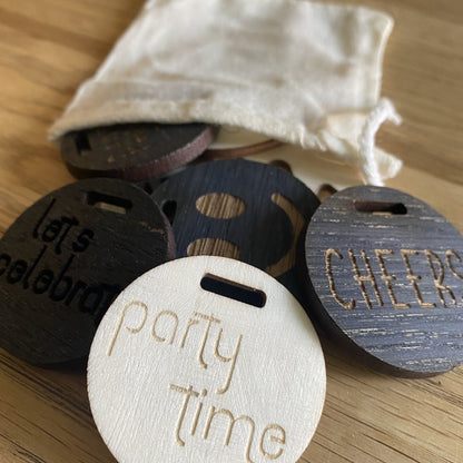Mixed selection of glow bottle gifting charms in different finishes and engraved designs
