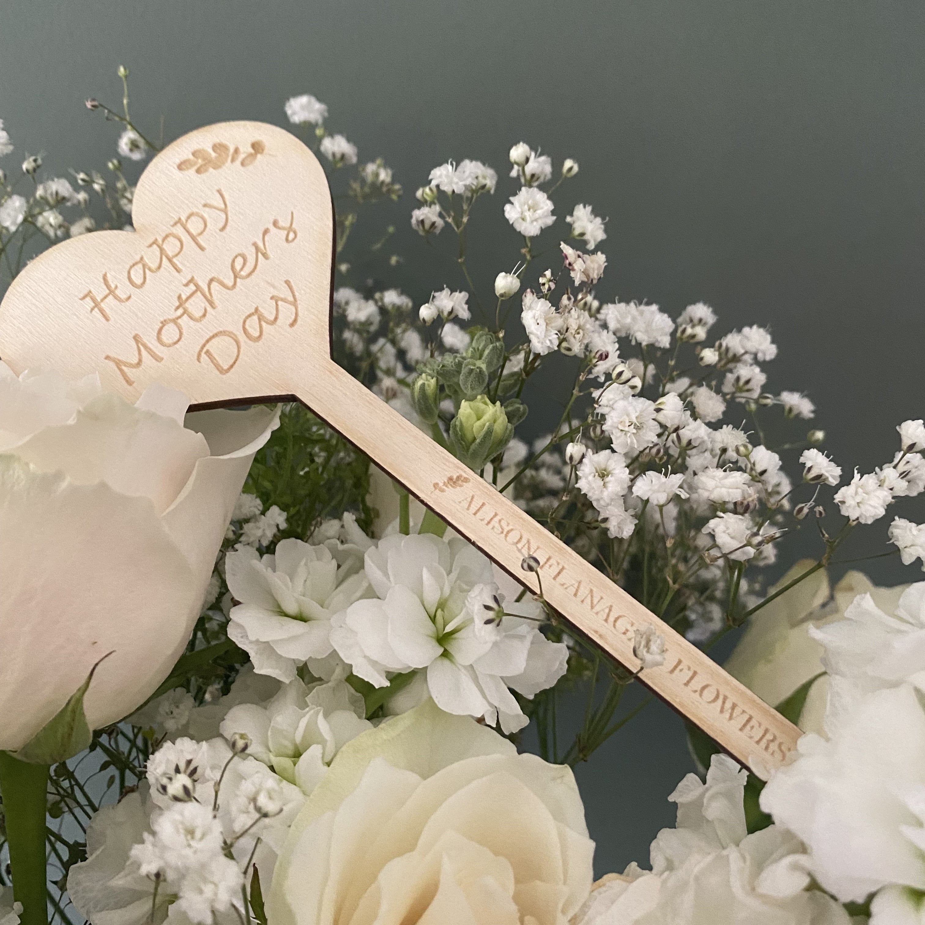 Wooden flower stakes engraved with florist logo, designed as Mother’s Day gifts