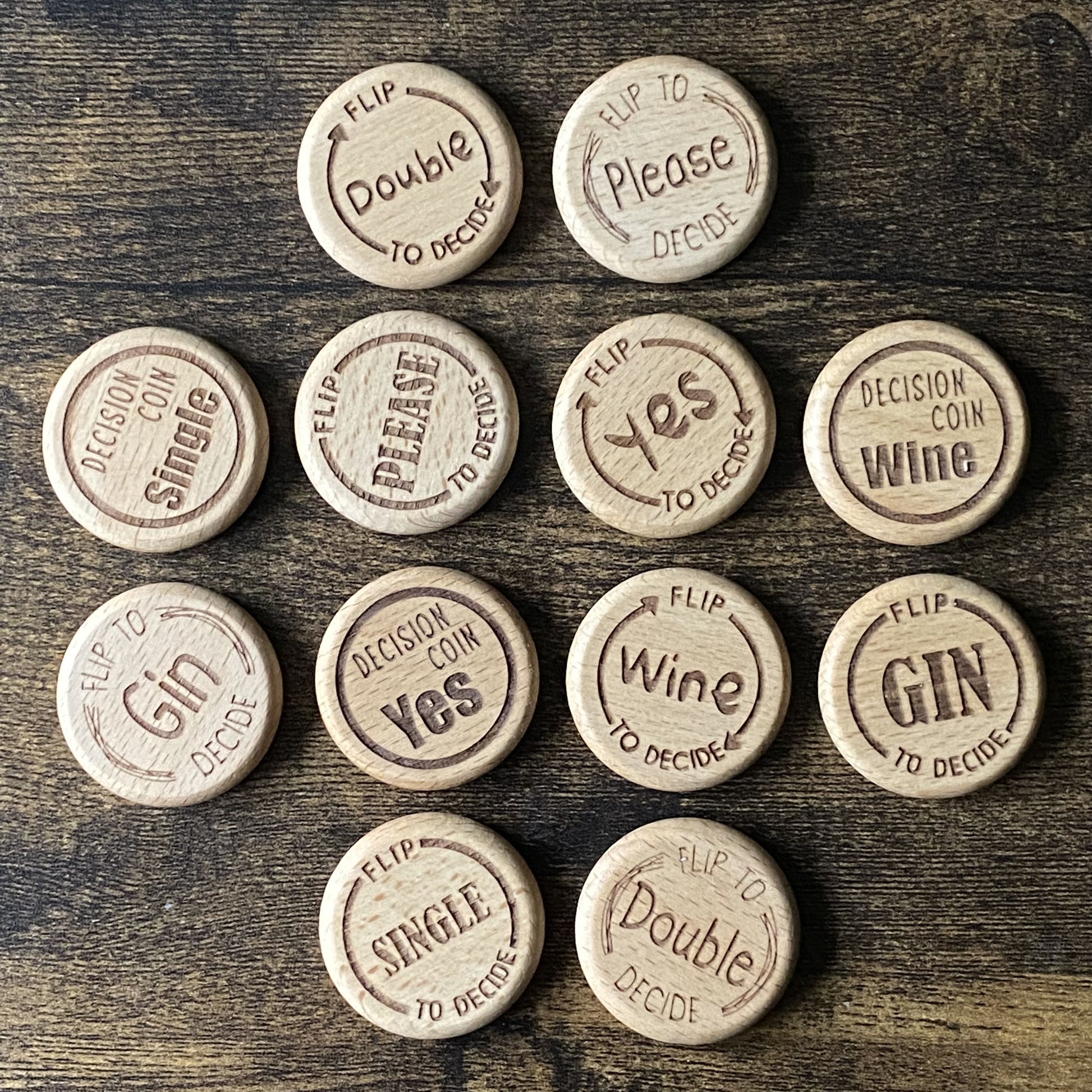 Top-down view of Friday Night Drinking Trio Flip Coins in a mix of all four designs, arranged to show engraving detail and variety