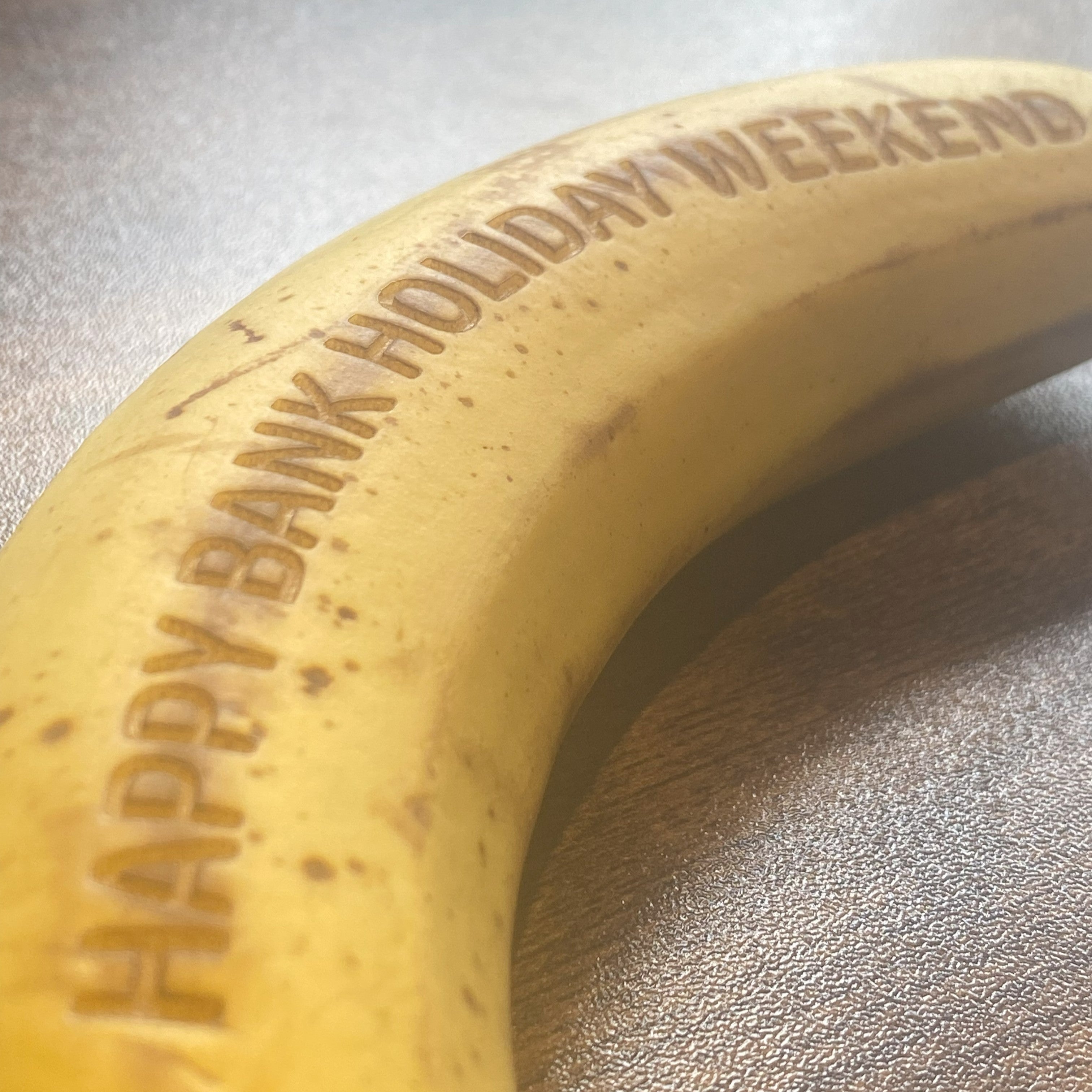 Intricate laser engraving artwork on the peel of a real banana, showcasing detailed design
