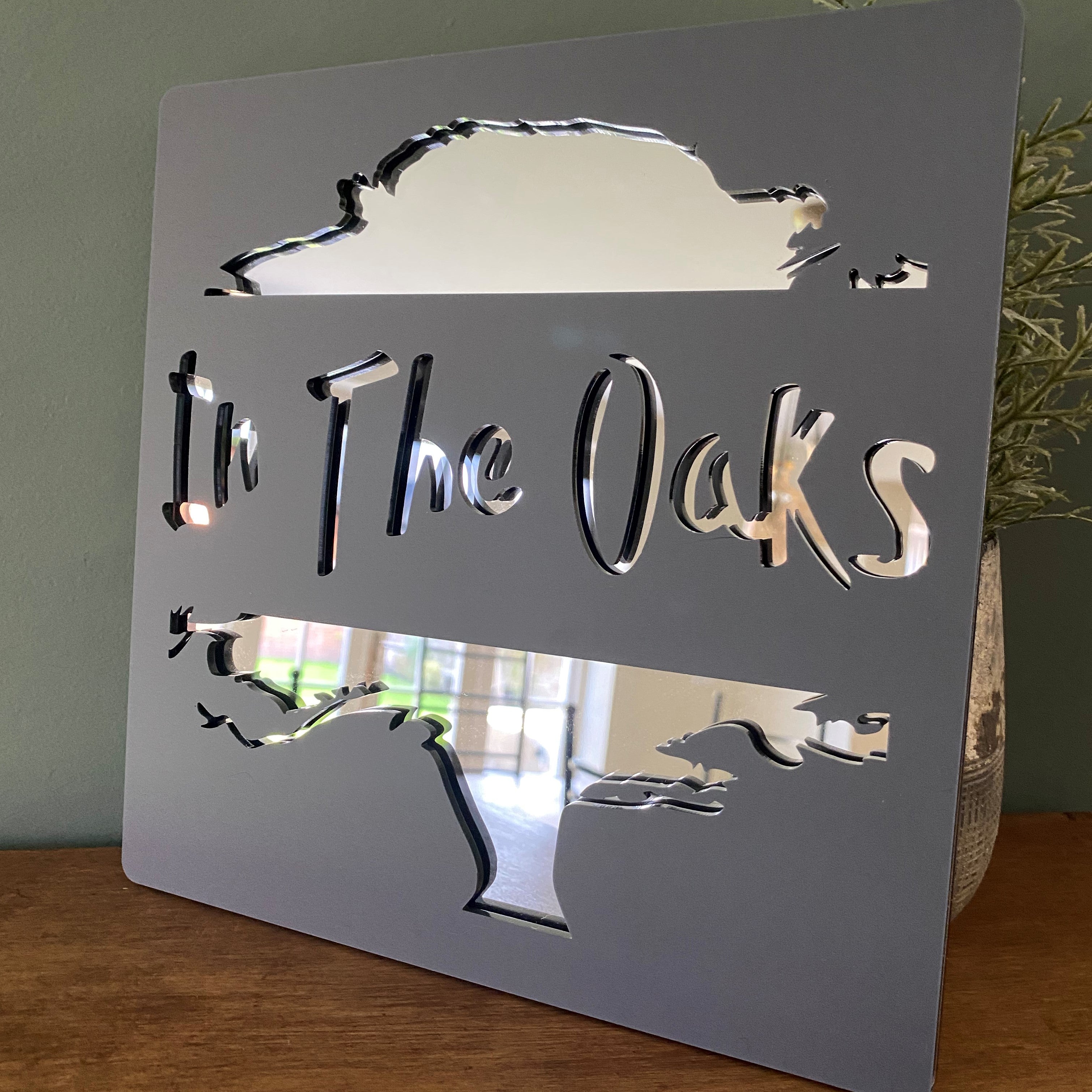 In The Oaks sign made from acrylic and mirror materials, showcasing modern design