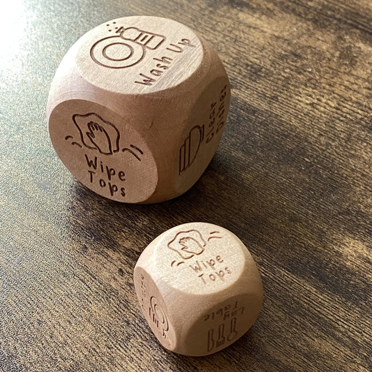 Pocket and jumbo sizes of Junior Chores Decision Dice shown side by side, featuring engraved kid-friendly chore illustrations