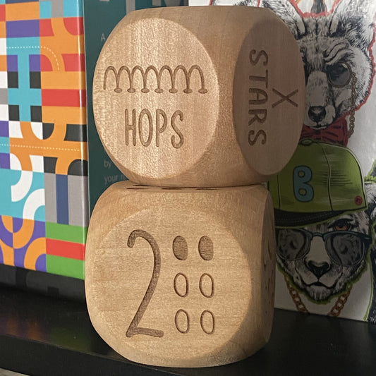 Stacked pair of Junior Exercise Decision Dice on shelf, showcasing engraved playful movement illustrations