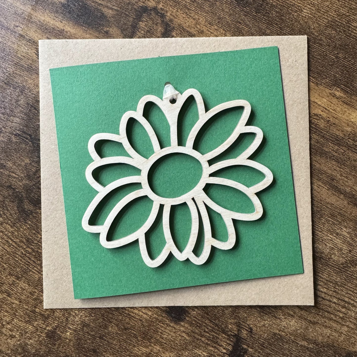 Wooden Keepsake Charm Card with Gerbera Flower design – features dark green background, laser cut wooden charm, and coordinating ribbon