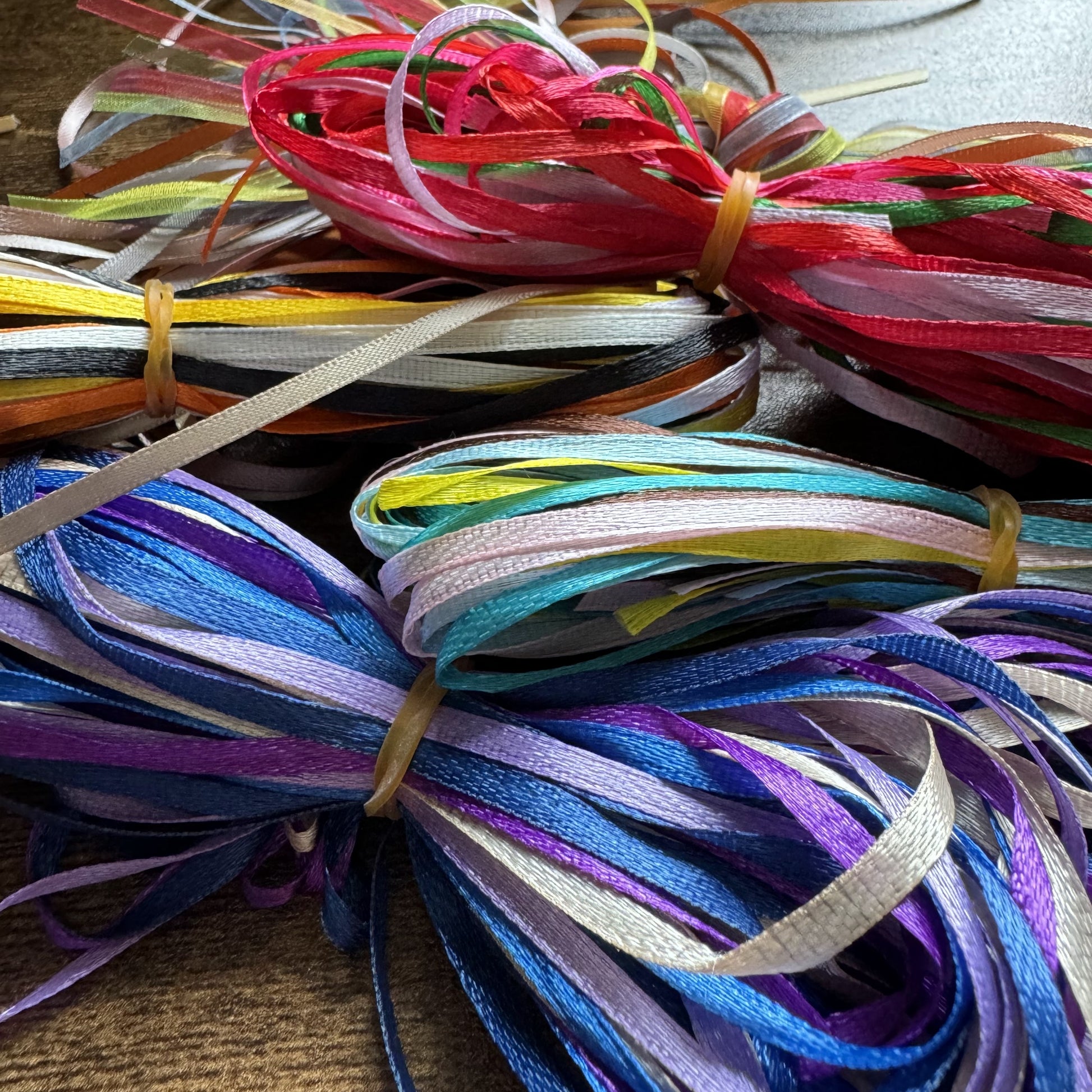 Selection of ribbon bundles in assorted colours and textures, styled for pairing with Keepsake Charm Cards
