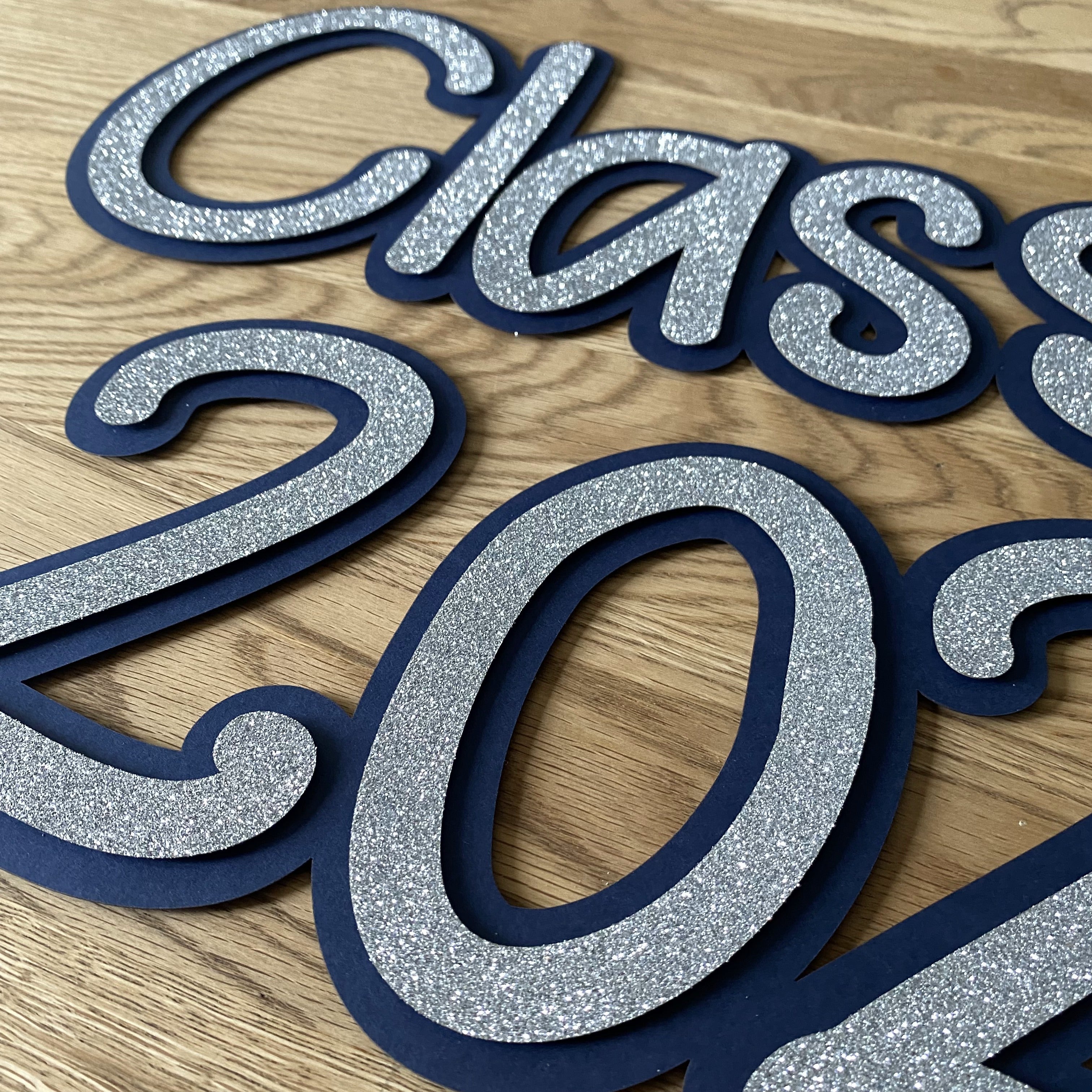 Large intricately laser-cut paper sign reading ‘Class of’ designed for prom events