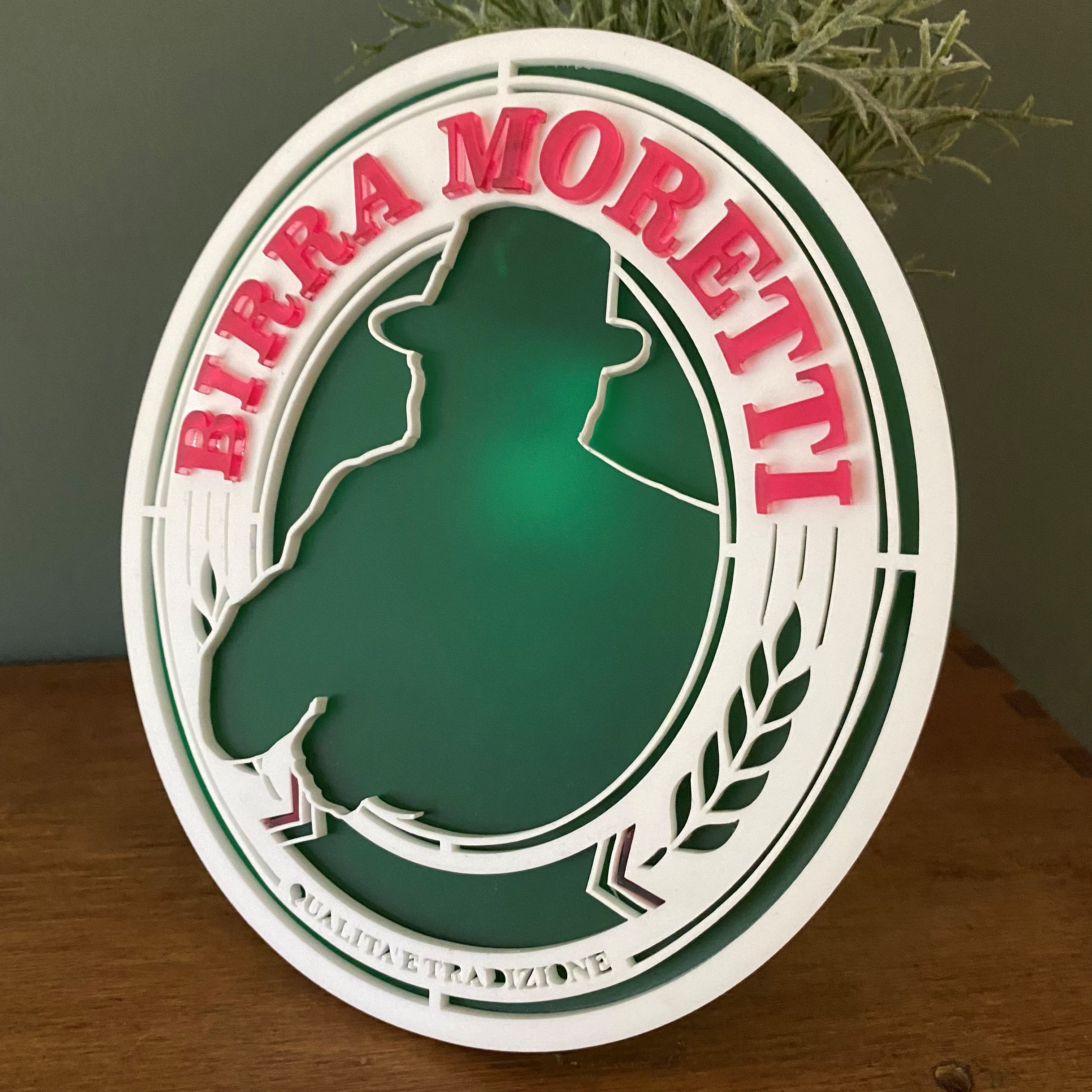Intricately cut layered plaque featuring a beer logo, created as a personalised tribute for funeral flower arrangements