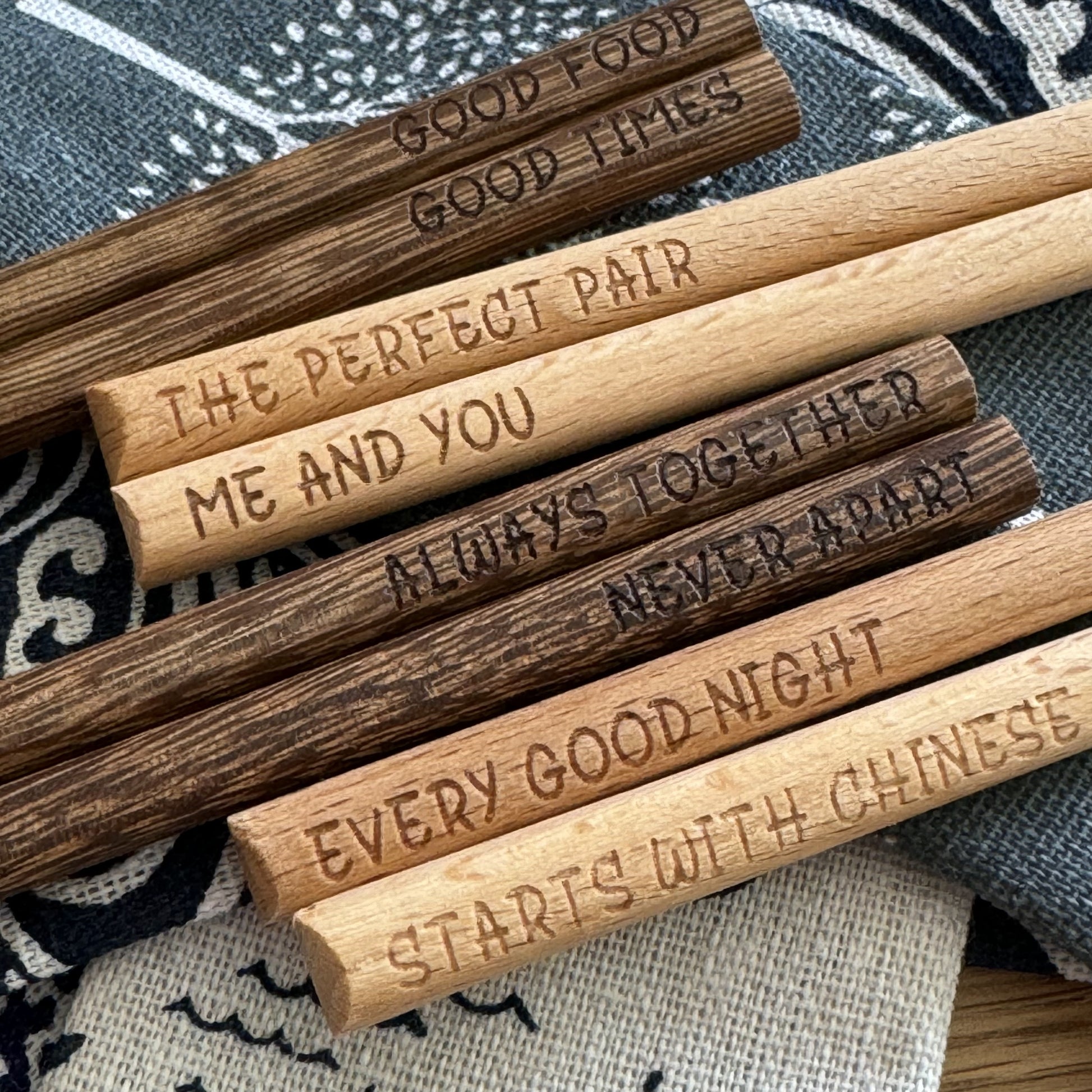 Engraved chopsticks arranged to show left- and right-handed engraving.