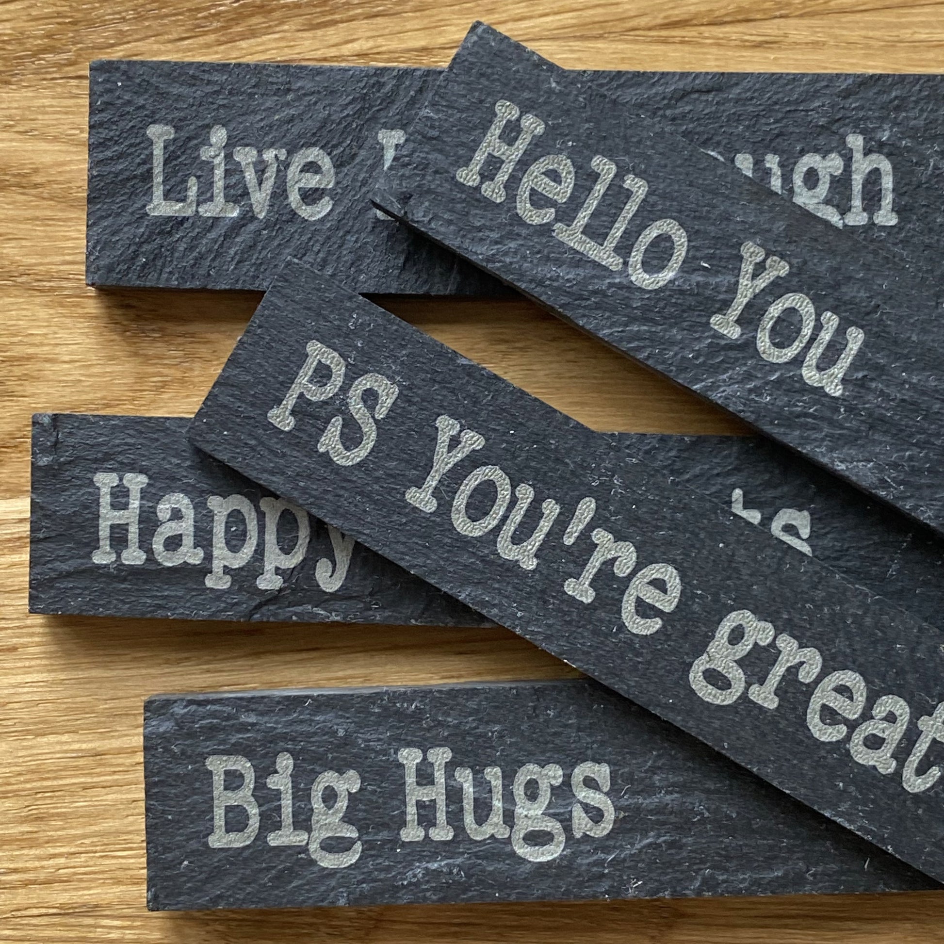 Selection of engraved slate plant markers from the Love and Affirmation ranges, featuring uplifting messages