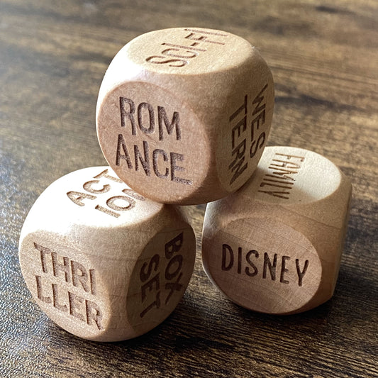 Stacked view of the Movie Night Trio Decision Dice set, showing all three engraved wooden dice with various film genres visible