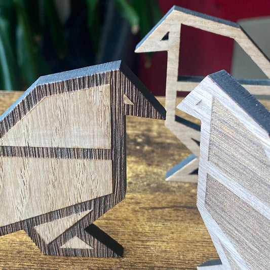 Pair of wooden birds in origami-inspired design, showcasing geometric lines and natural wood tones