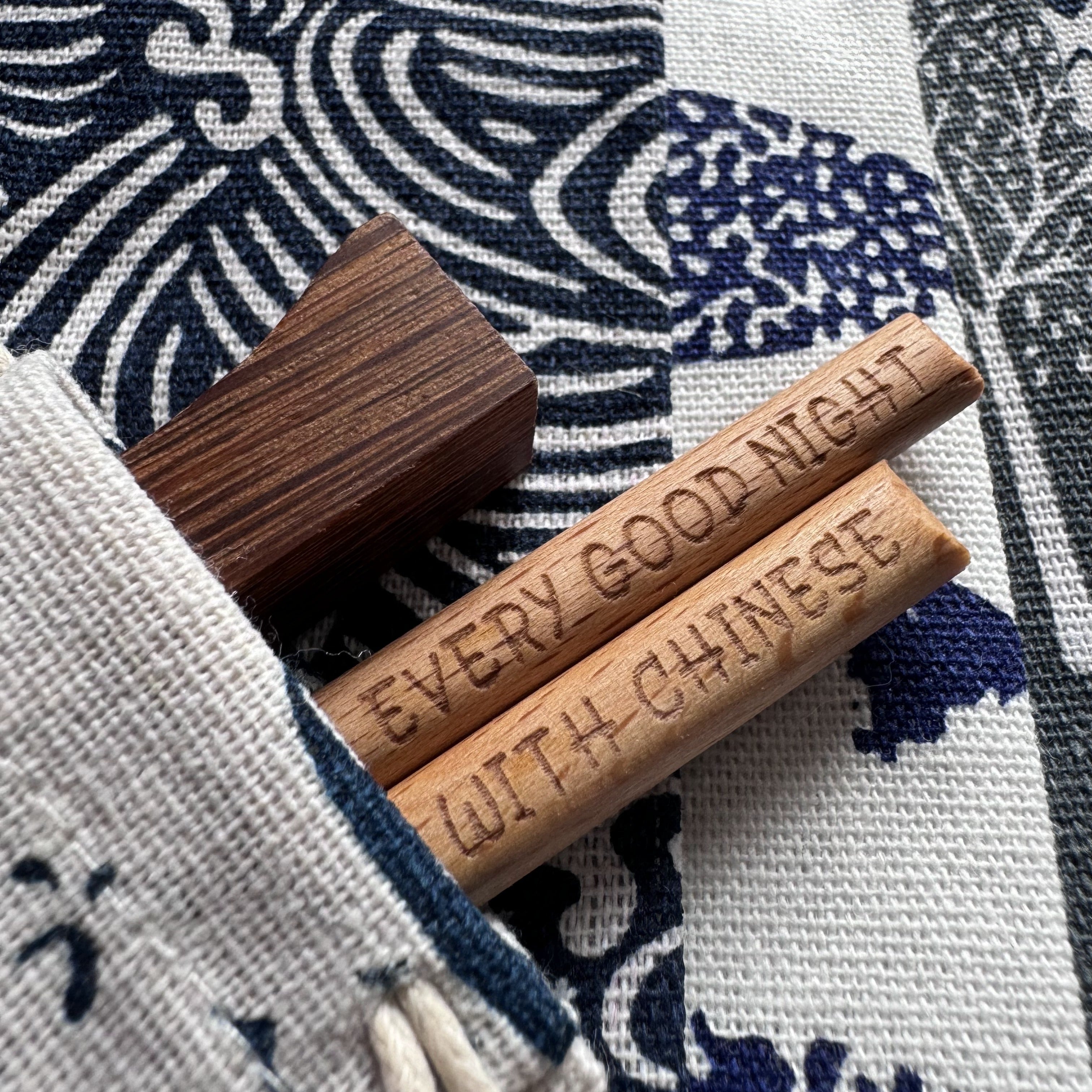 Chopsticks and rest tucked neatly in fabric pouch with bamboo pair peeking out.