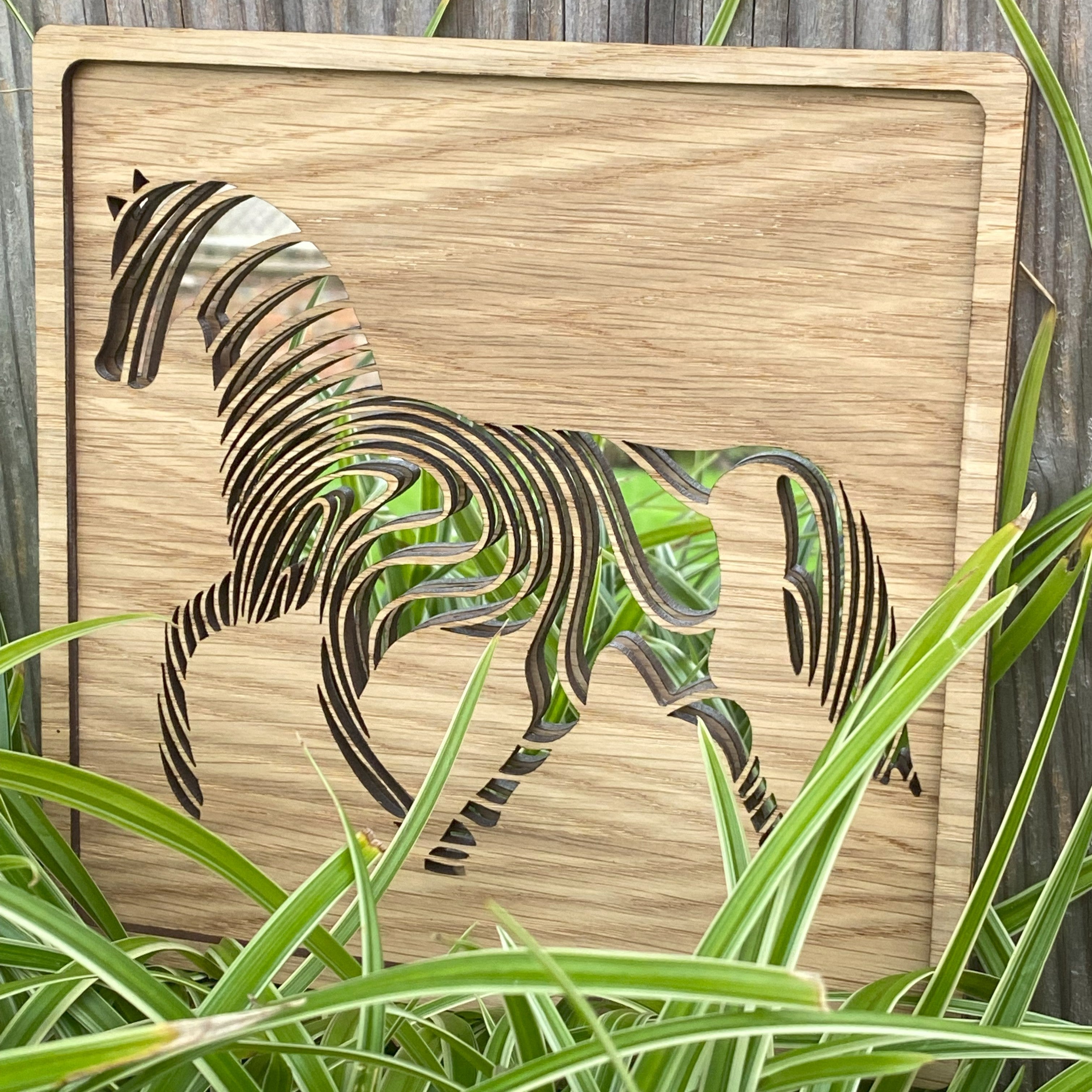 Rainbow-inspired mirror horse art piece displayed in a outdoor setting