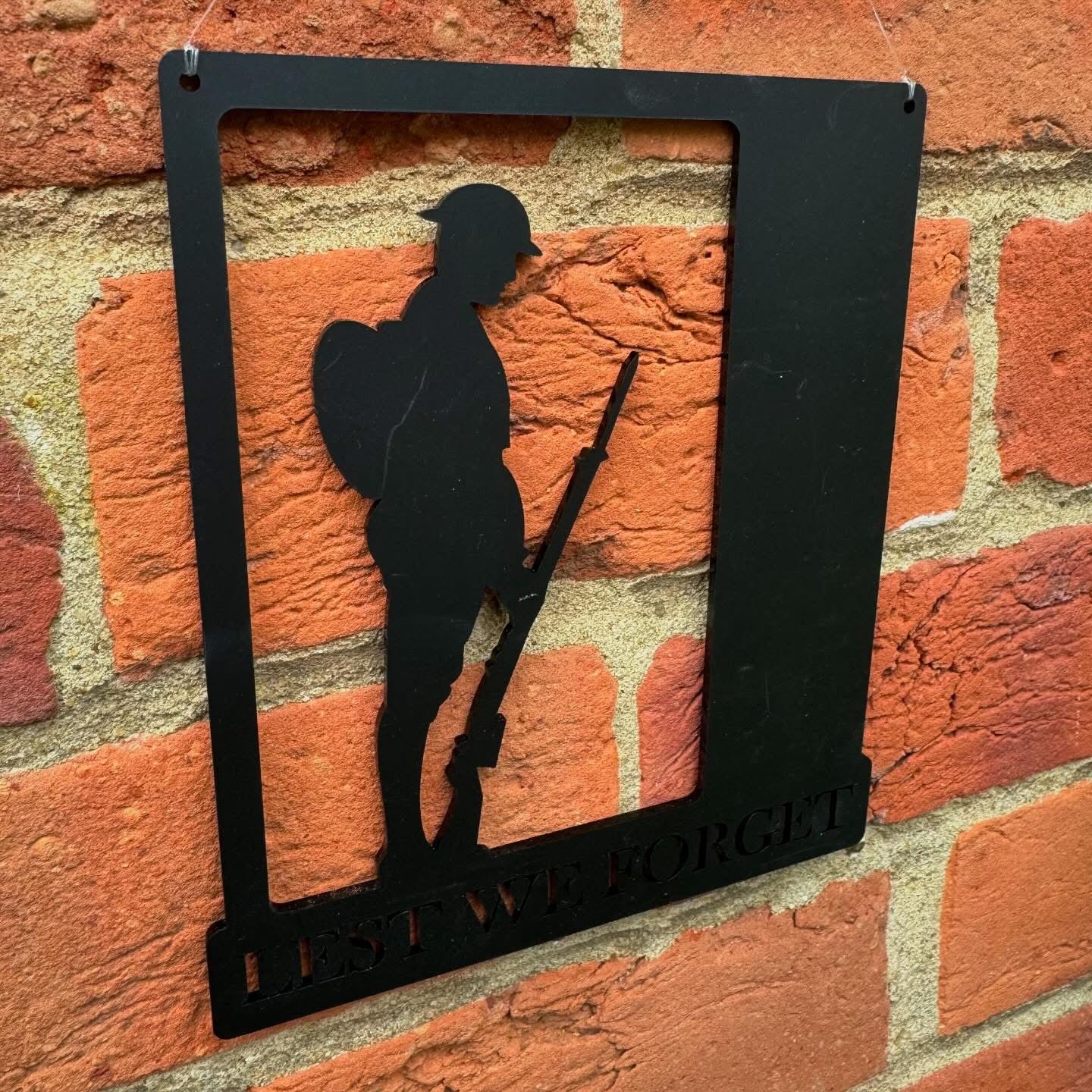 Wall-hanging display created for Remembrance Day, featuring thoughtful silhouette detailing and classic commemorative design